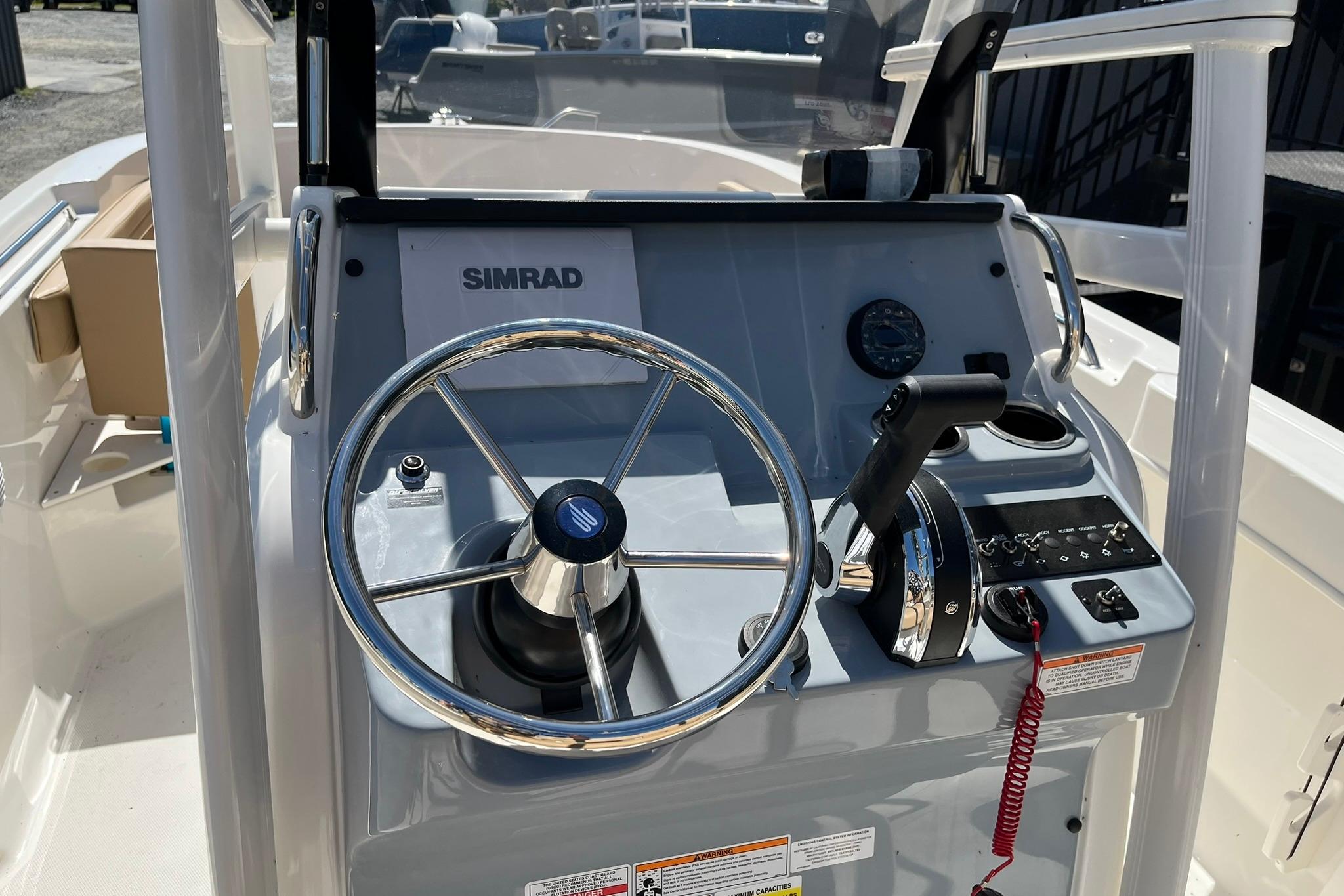 2026 Bayliner Trophy T22CC boat dashboard with steering wheel and controls.
