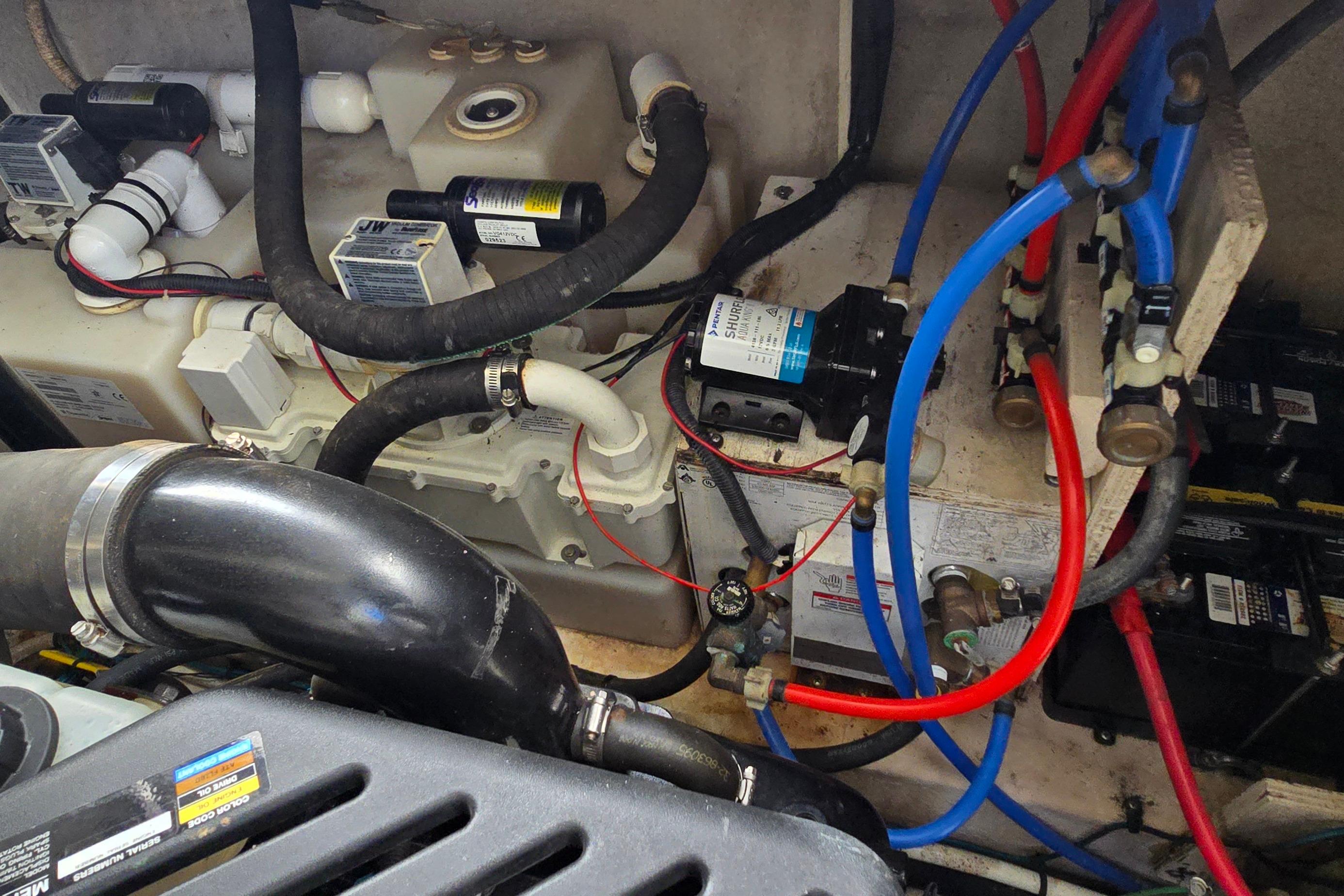 Engine compartment of a 2007 Sea Ray 340 Sundancer with visible hoses and wiring.