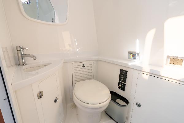 2020 HCB 53 Sueños boat bathroom with modern fixtures and white interior.
