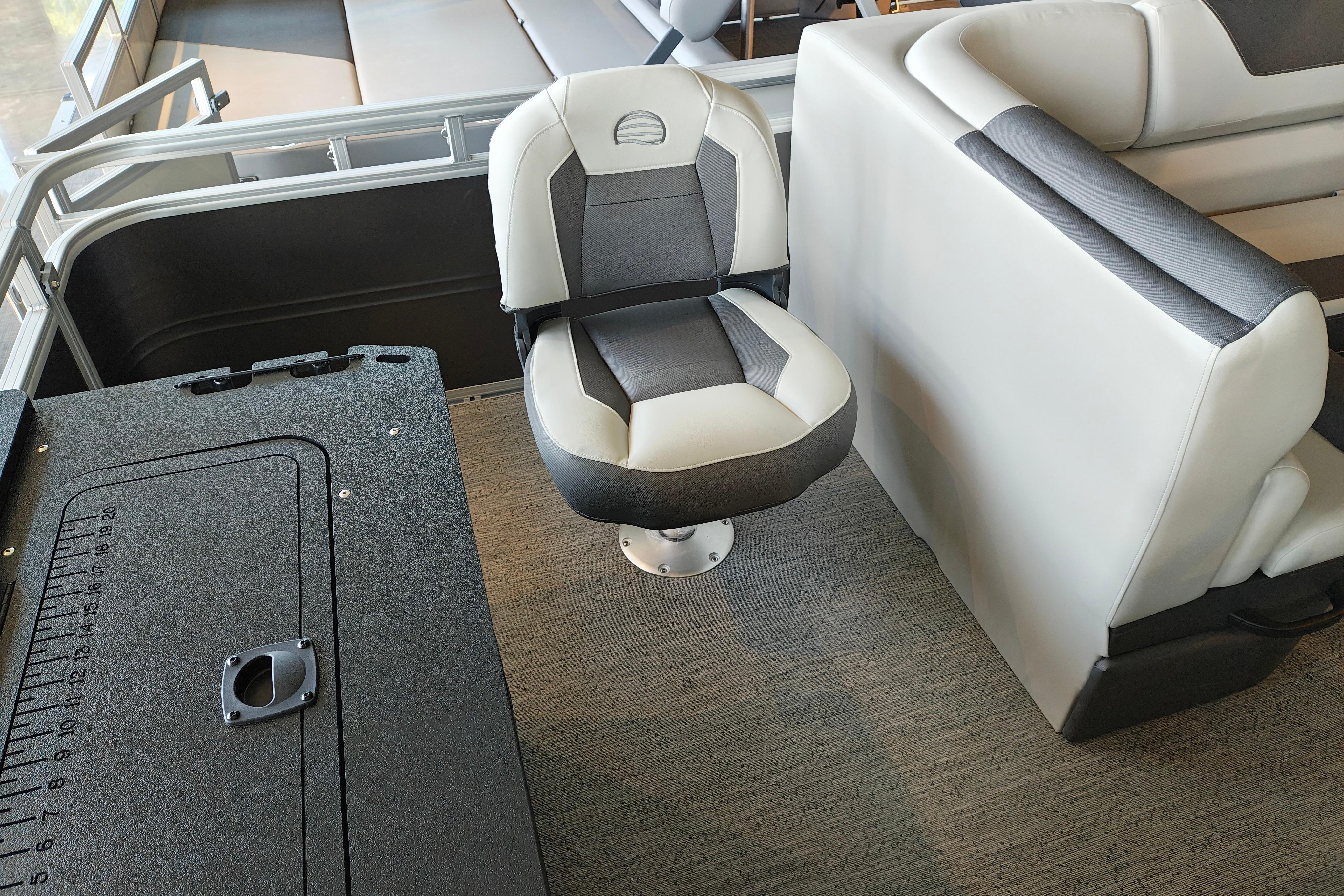2026 Sun Tracker Fishin' Barge 22 XP3 interior with swivel seat and storage compartment.