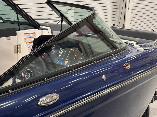 2026 Chaparral SSX 6 boat with sleek blue design and modern dashboard.