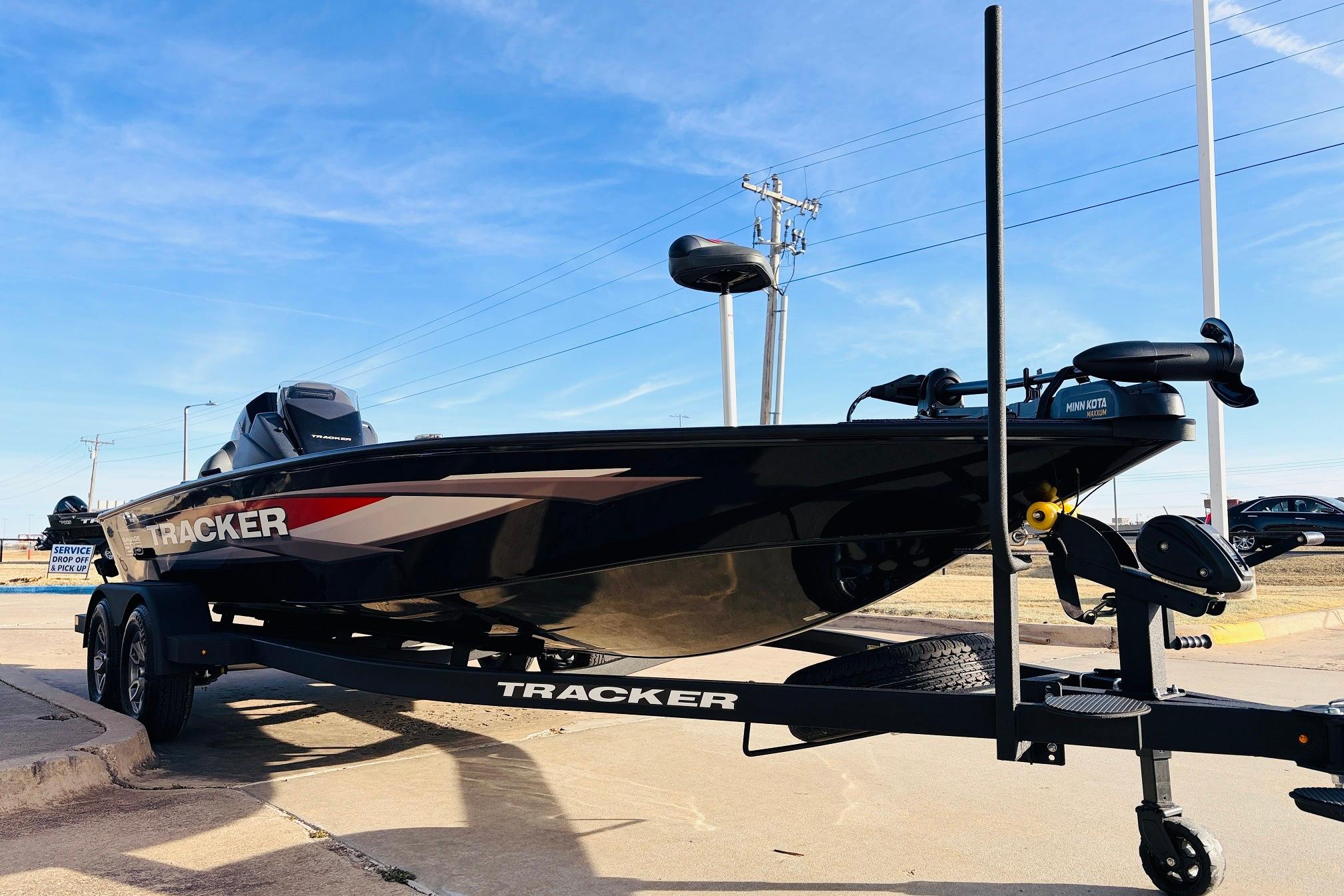 2025 Tracker Savage 215 boat on trailer under clear blue sky.