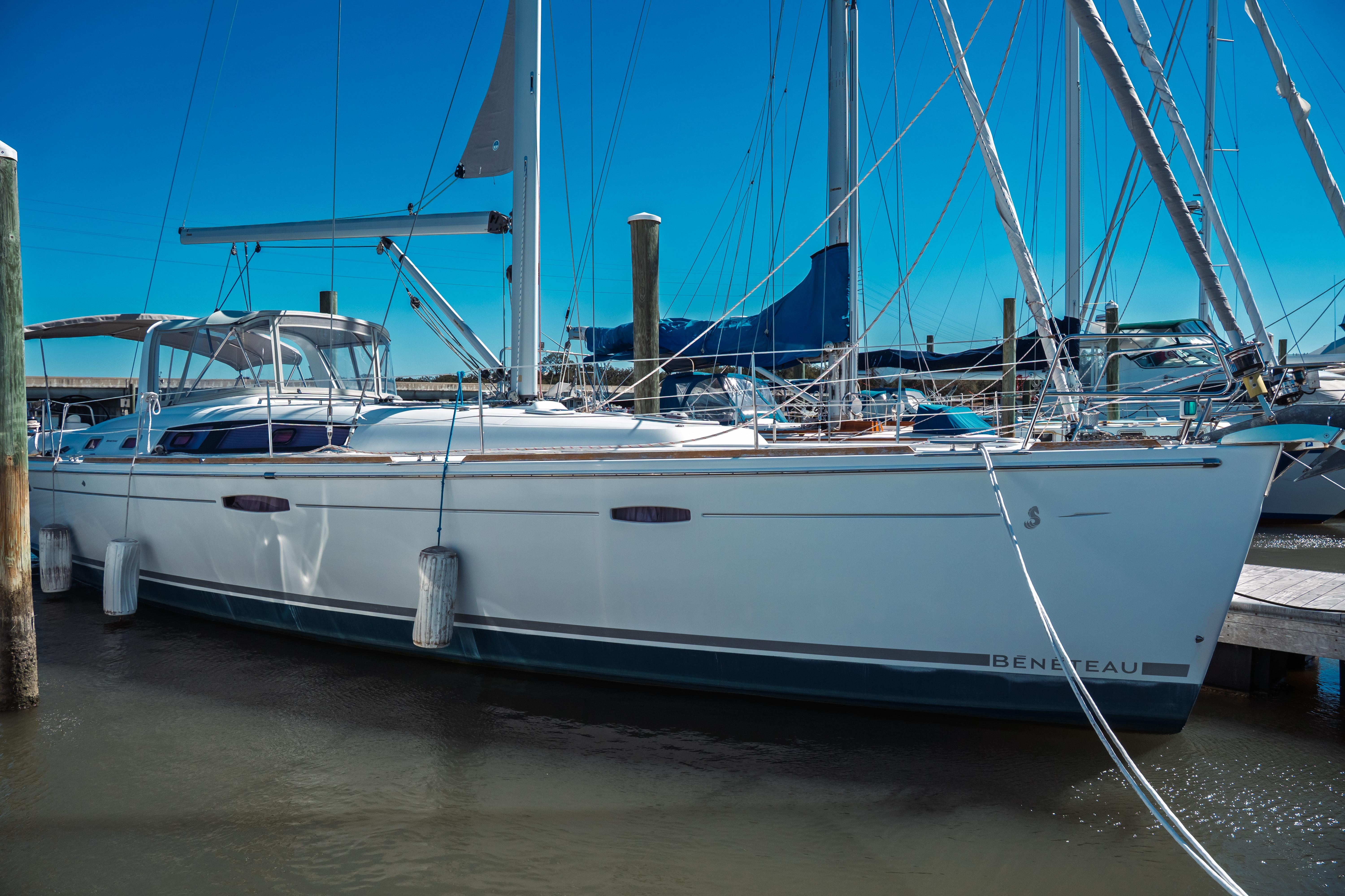 2011 Beneteau Oceanis 50 sailboat docked at marina under clear blue sky.