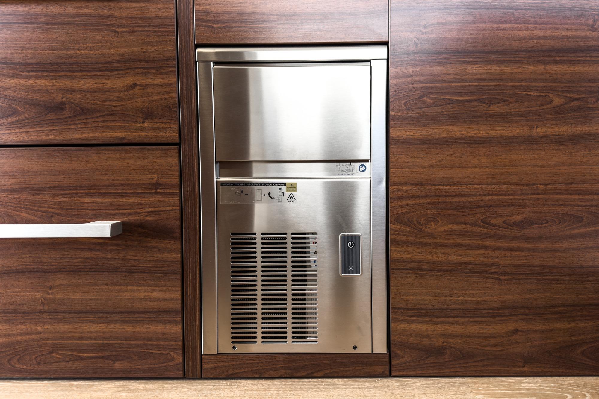 Built-in stainless steel appliance on Maritimo M55 yacht, 2026 model, with wood paneling.