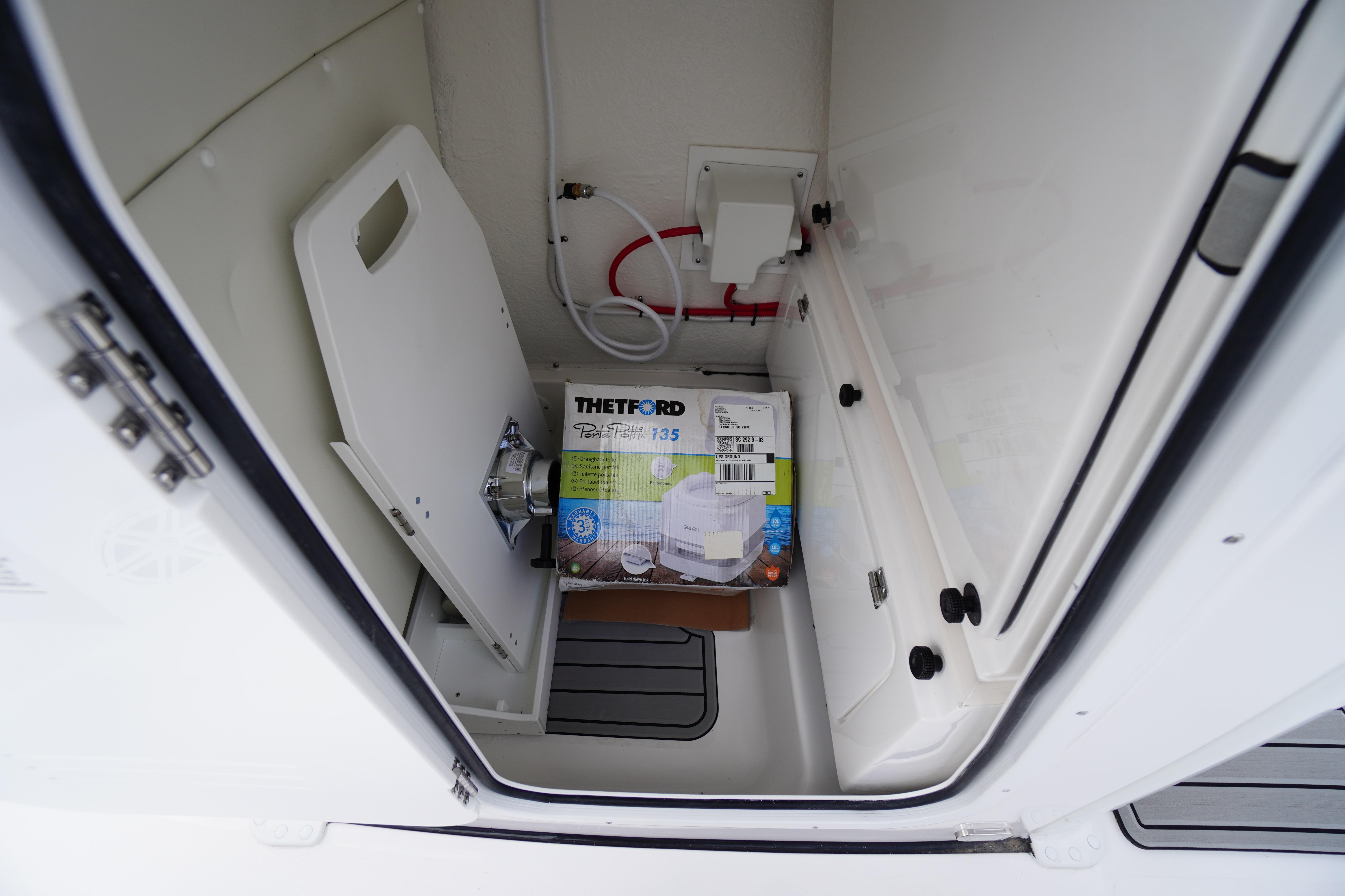 Interior of 2026 Tidewater 232 LXF boat with Thetford Porta Potti.