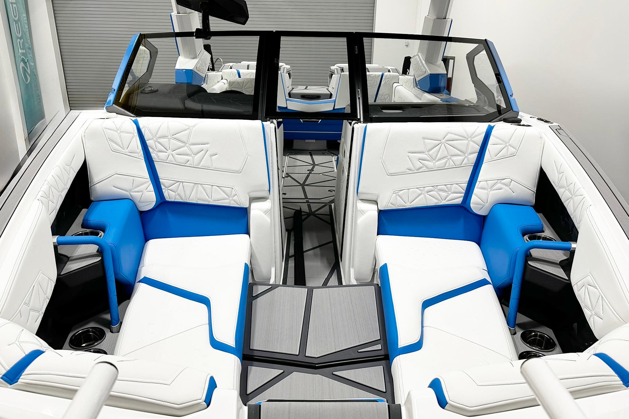 2025 Nautique Super Air Nautique G23 Paragon interior with white and blue seating.
