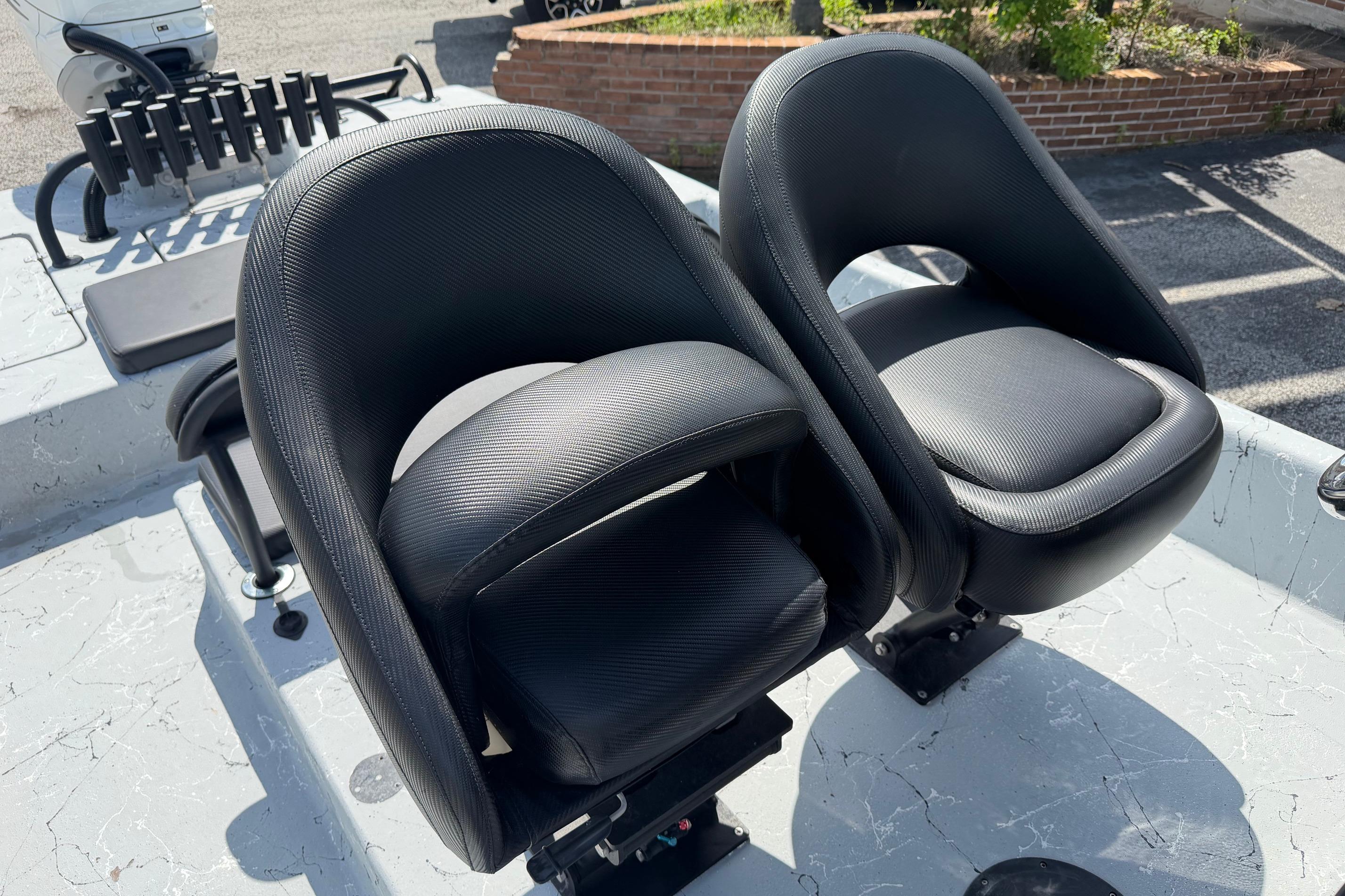 Two black seats on a 2023 Haynie 23 Super Cat boat deck.