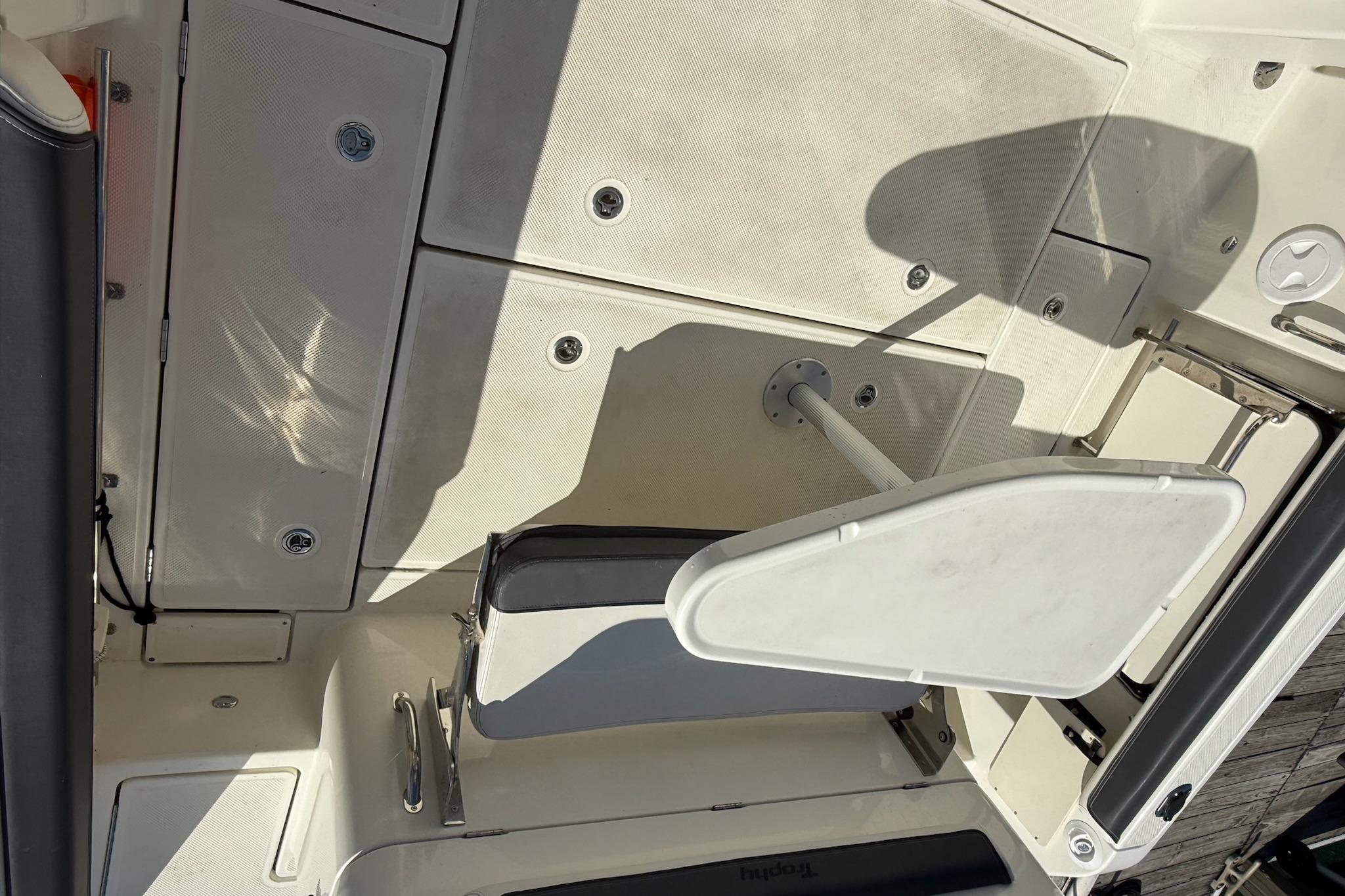 2024 Bayliner Trophy T25 Pilothouse interior with seating and storage compartments.