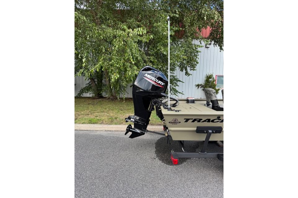 2026 Tracker Grizzly 1754 SC boat with Mercury outboard motor, parked outdoors.