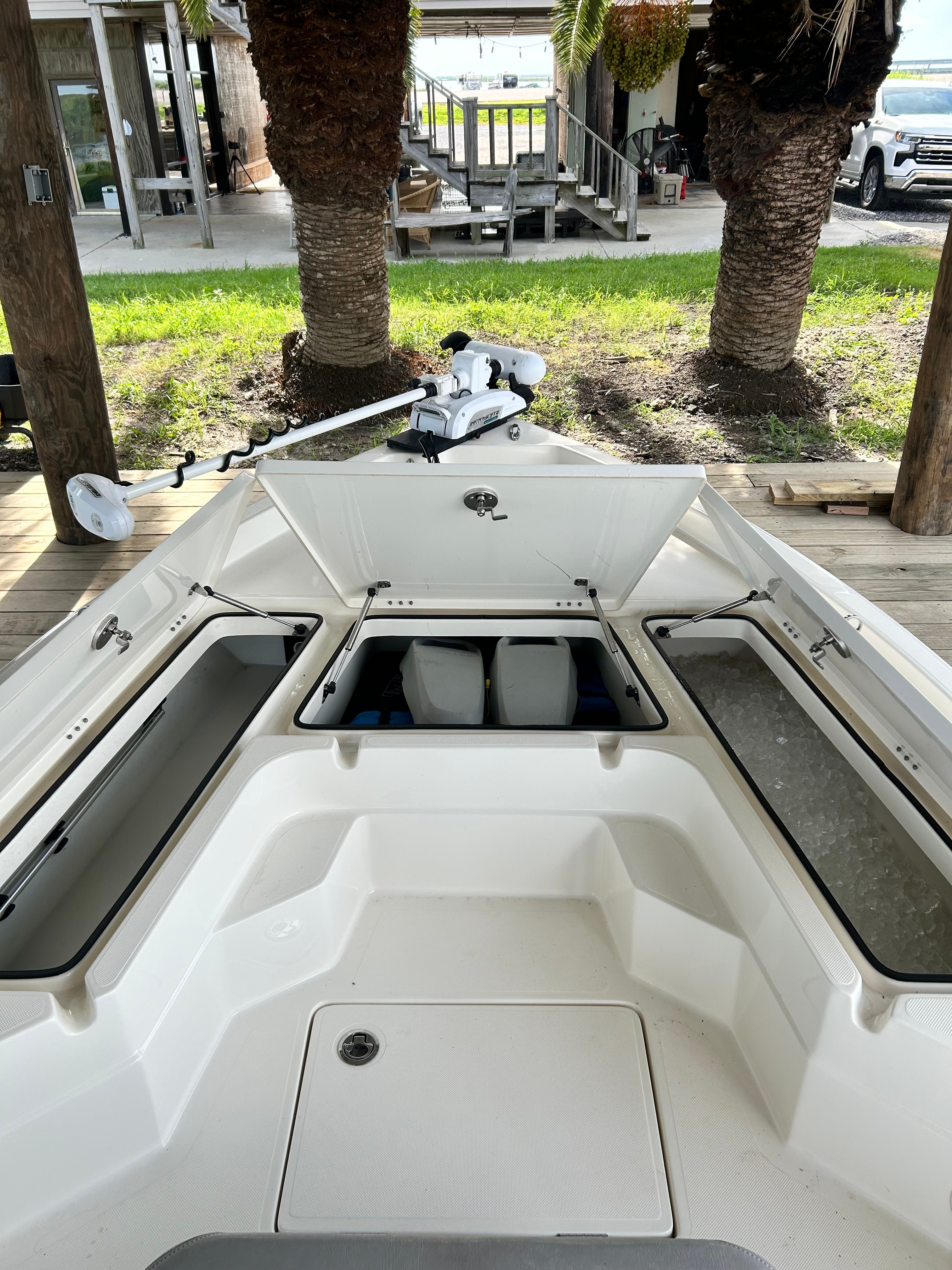 The image shows the open deck of a 2016 Skeeter SX230 boat with storage compartments.