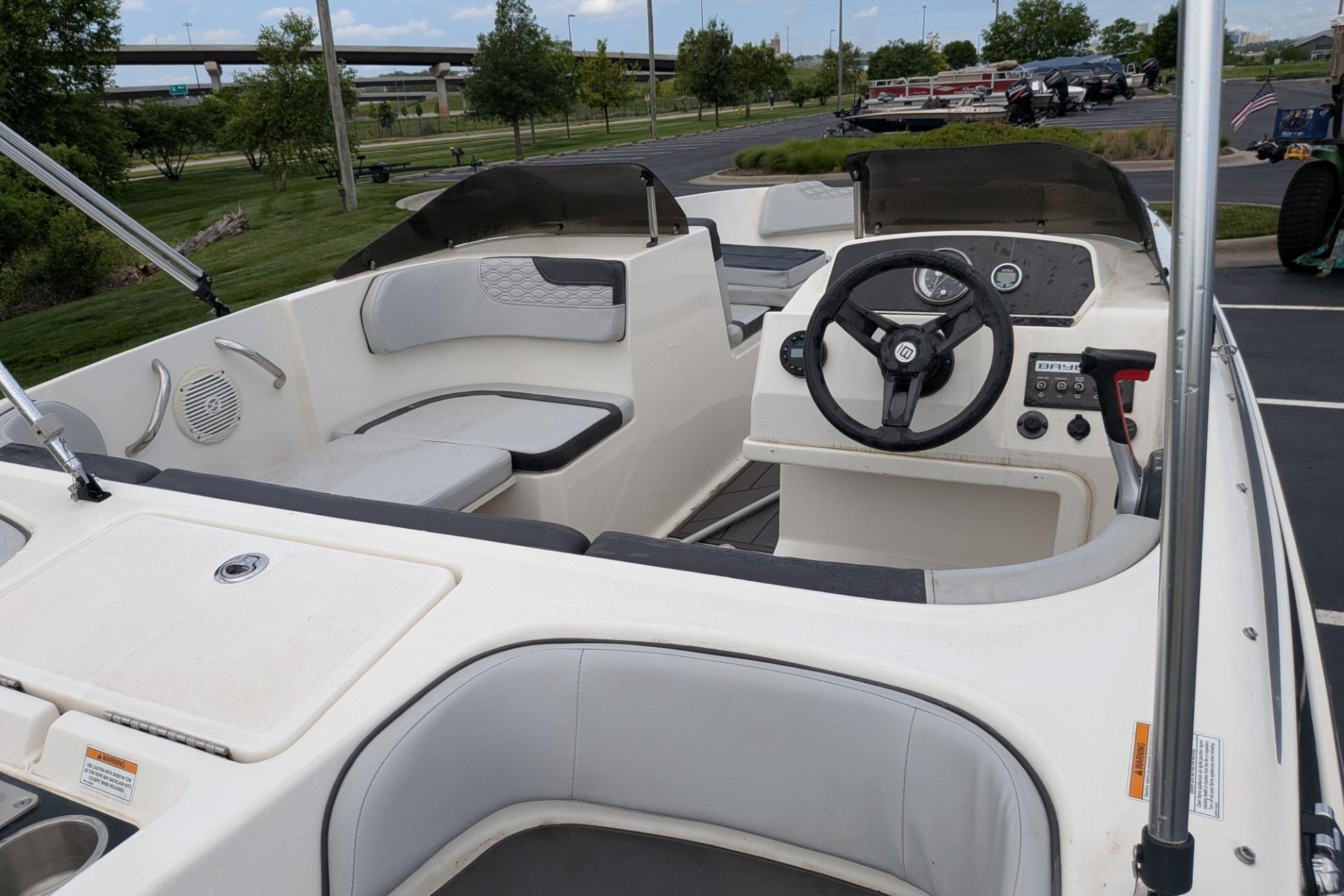 2023 Bayliner Element M17 boat interior with steering wheel and seating area.