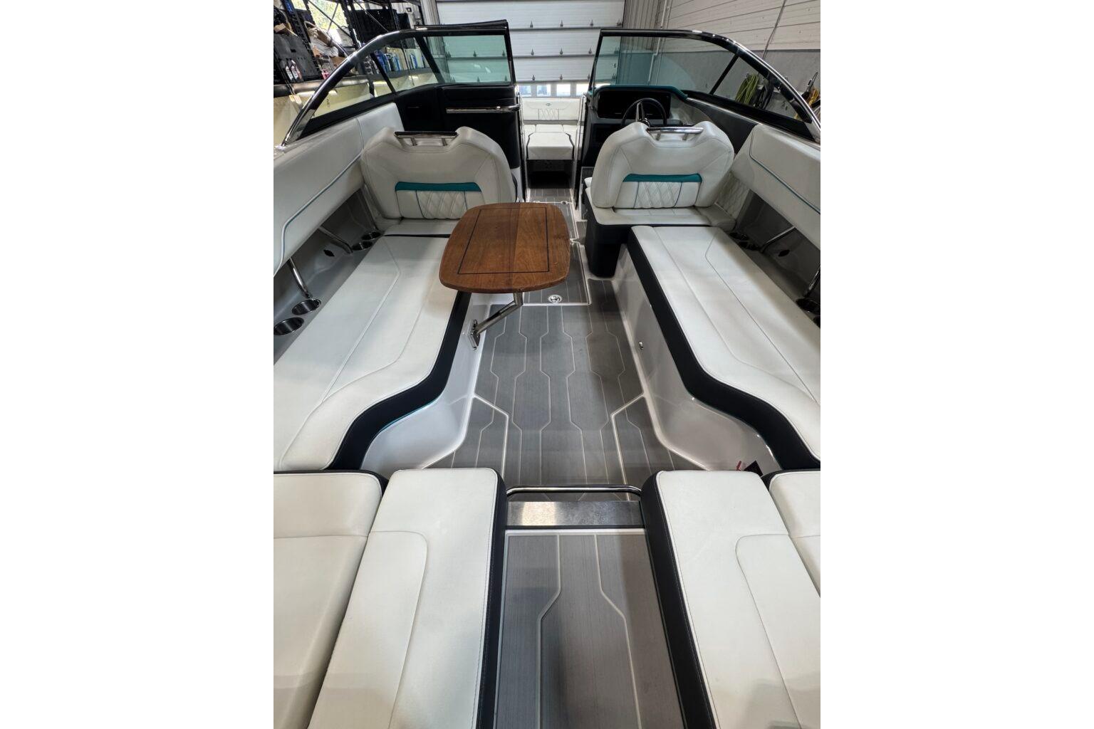 2022 Regal LS6 Surf boat interior with sleek seating and wooden table.