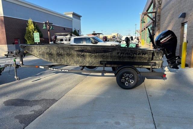 2026 Tracker Grizzly 1650 T Prairie Wings Edition boat on trailer, parked on street.