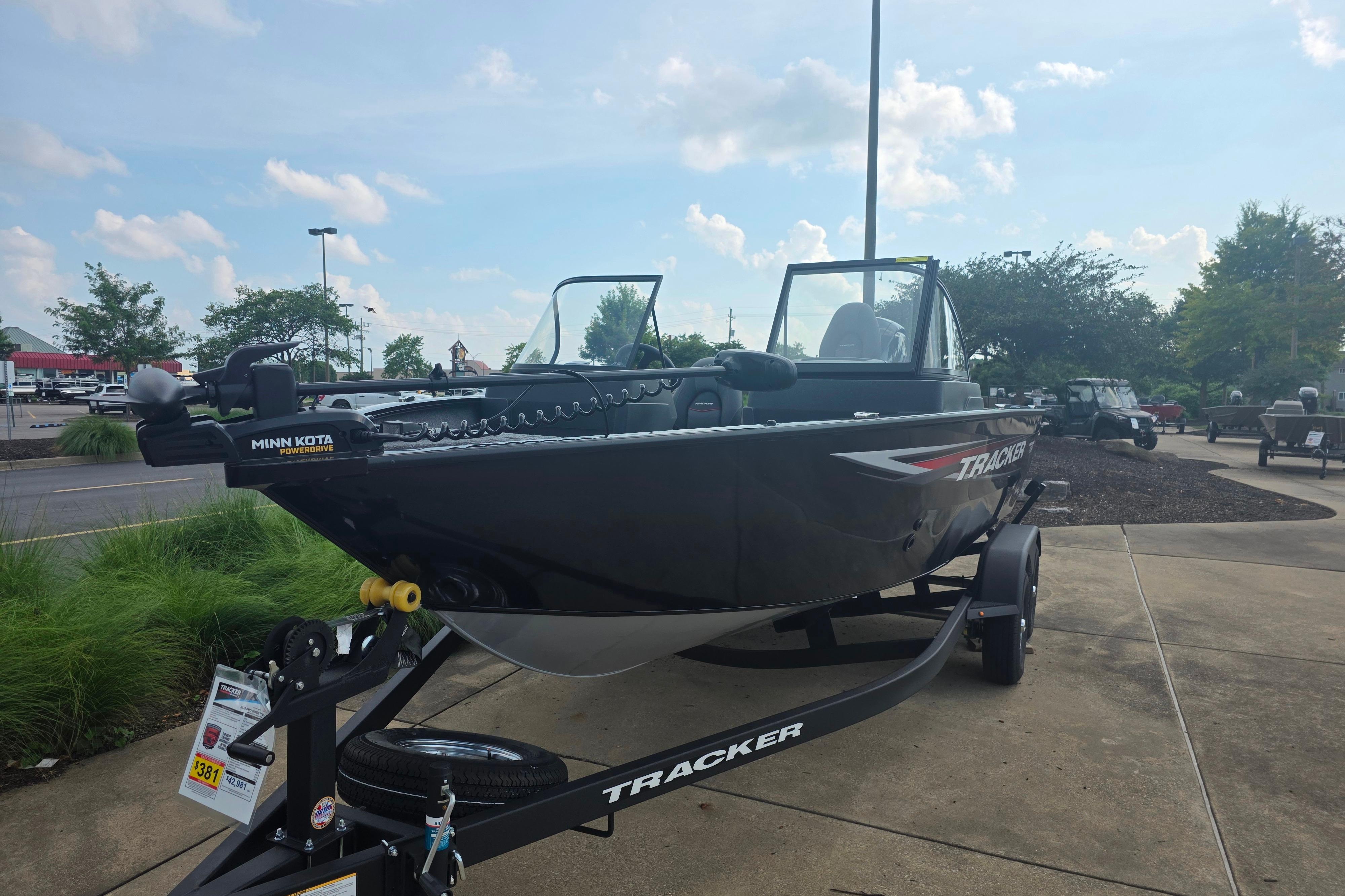 2026 Tracker Pro Guide V-175 Combo boat on trailer, parked outdoors under a clear sky.