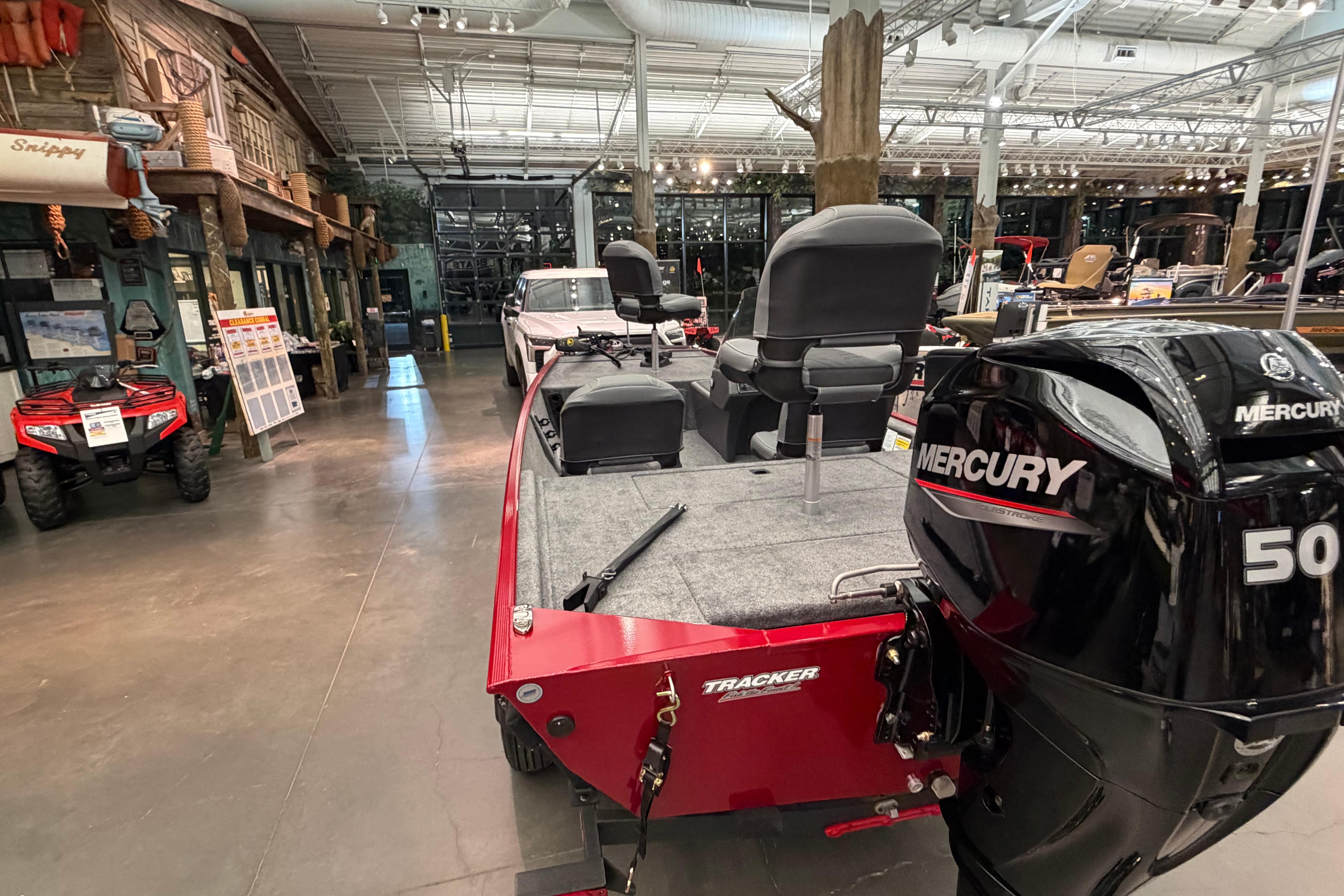 2026 Tracker Bass Tracker Classic XL boat with Mercury engine in showroom.