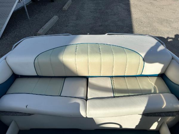 1995 Larson 174 SEI boat interior with white and teal seating.