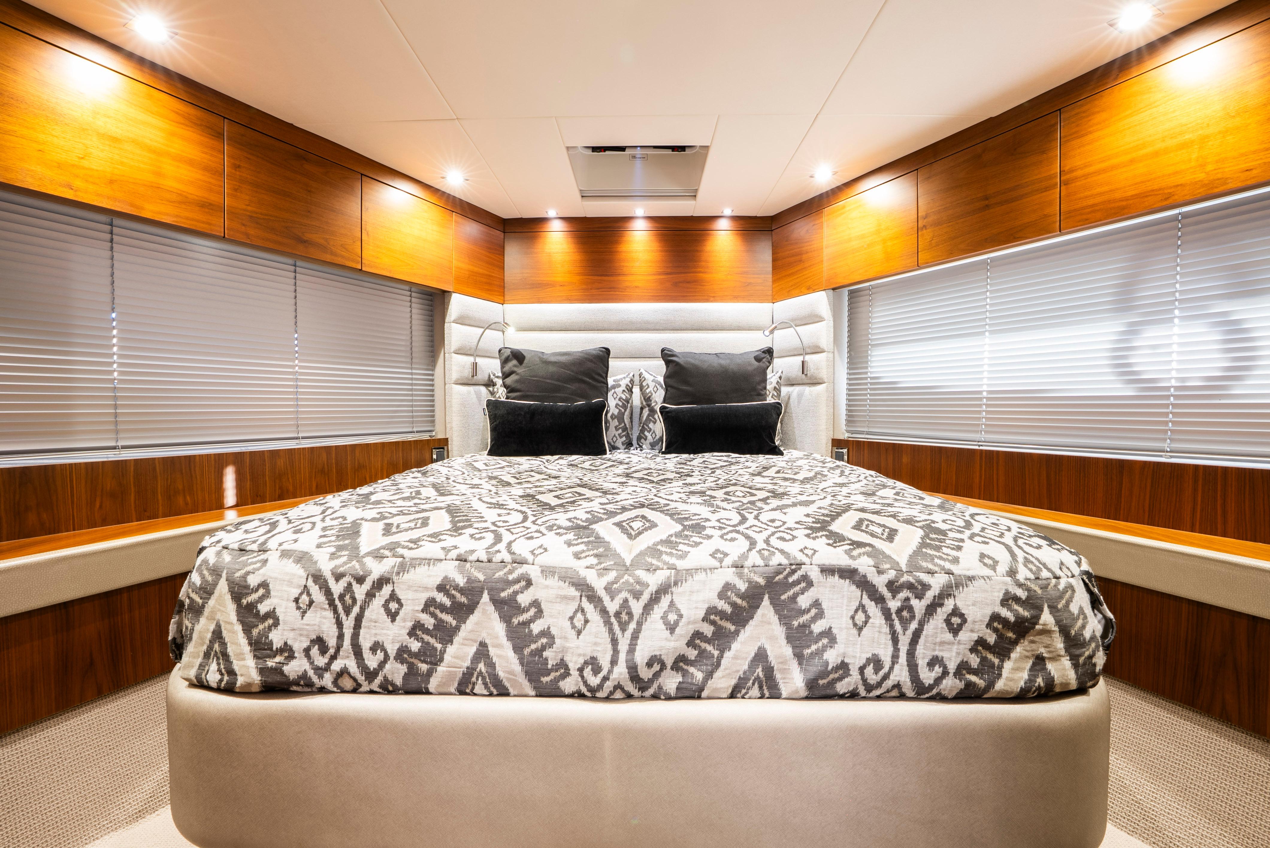 Luxurious bedroom interior of 2017 Sunseeker Manhattan 66 yacht with modern decor.