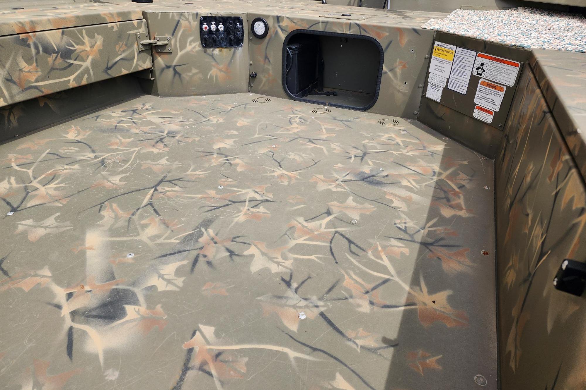 2022 GRIZZLEY 1654SPT boat interior with camouflage pattern and control panel.