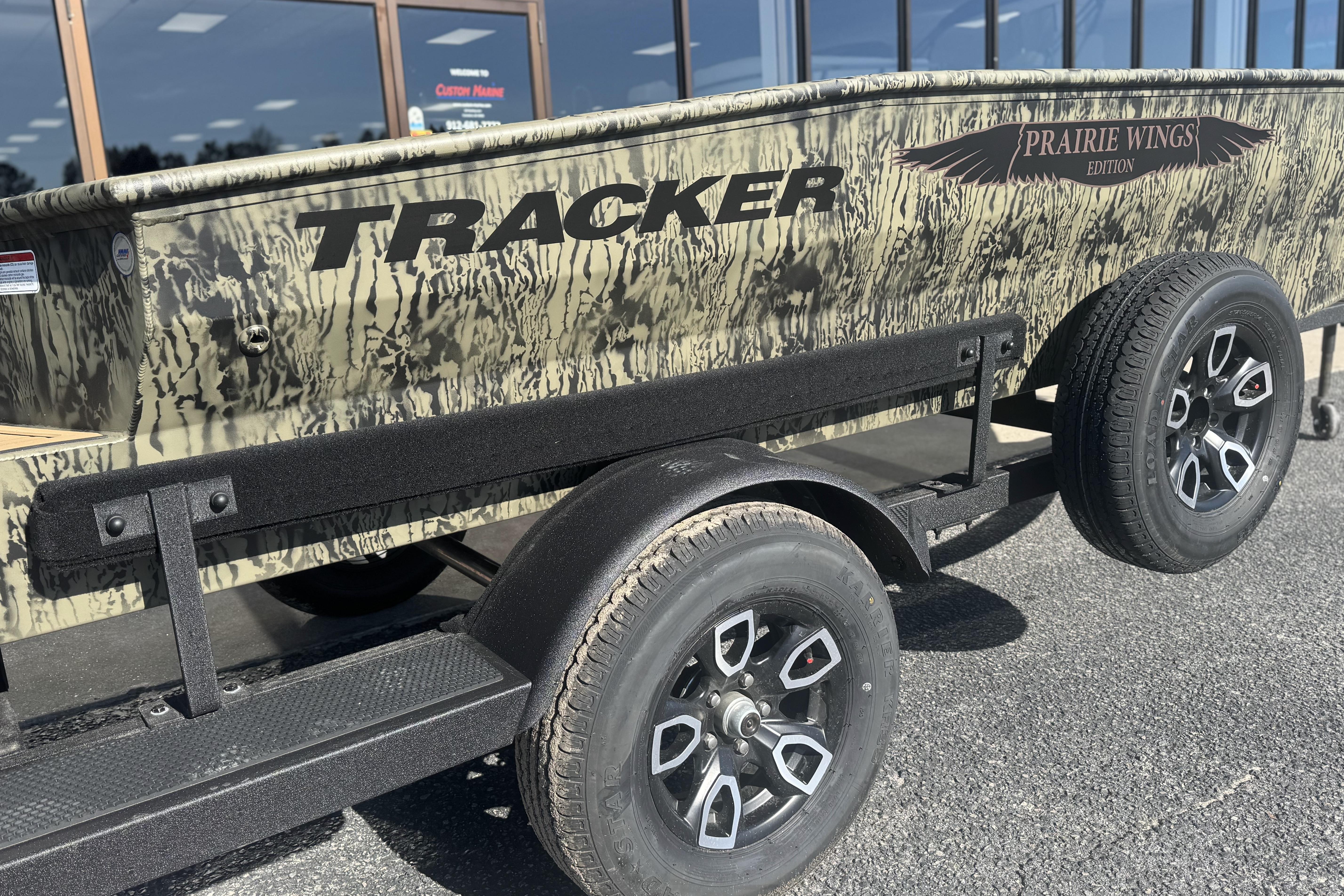 2026 Tracker Grizzly 1650 T Prairie Wings Edition boat on trailer, camo design.