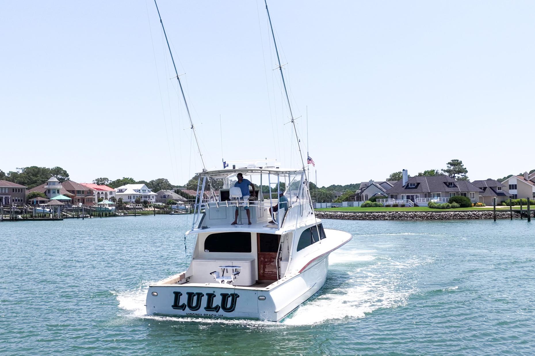 1998 Blackwell Custom Carolina Sportfish boat cruising near waterfront homes.