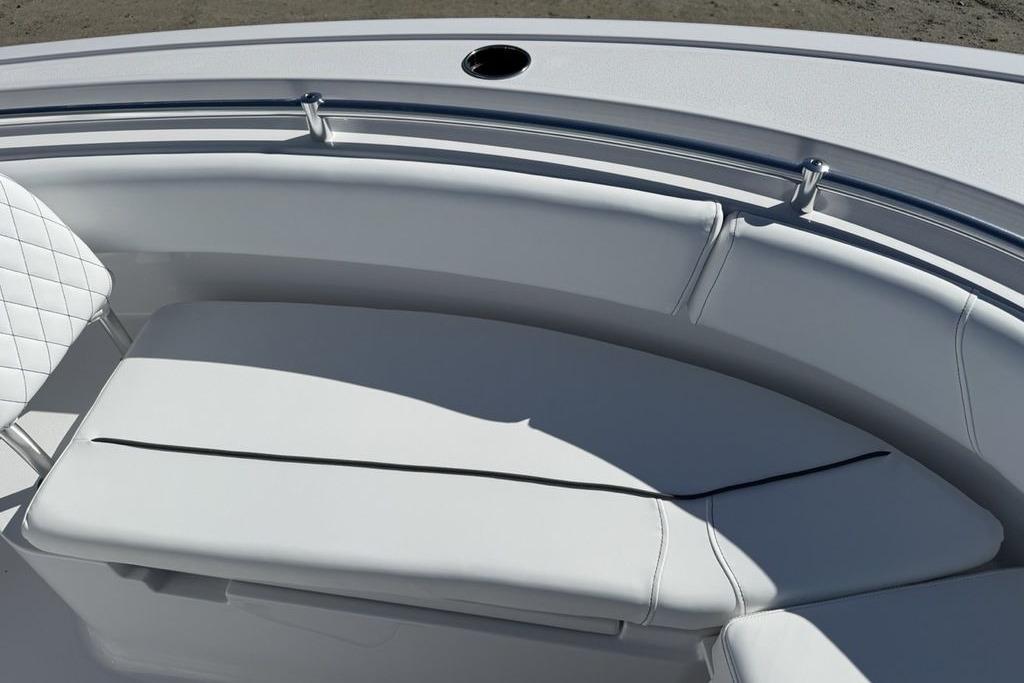 2026 Sportsman Open 232 Center Console boat with cushioned seating and stainless steel railing.