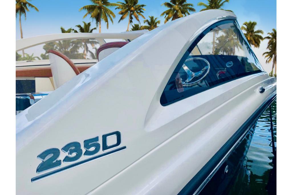 2023 Scout 240 Dorado boat with palm trees in the background.