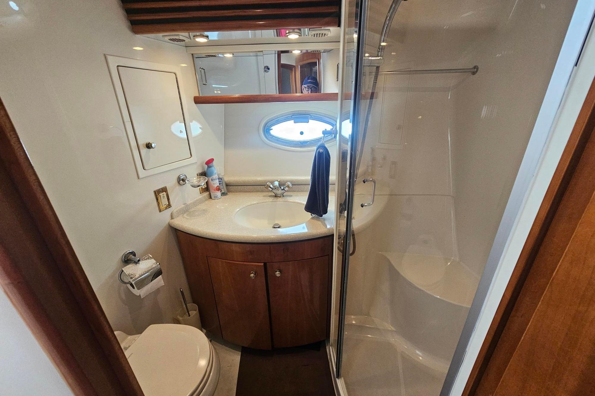Bathroom interior of 2002 Carver 450 Voyager Pilothouse with shower and vanity.