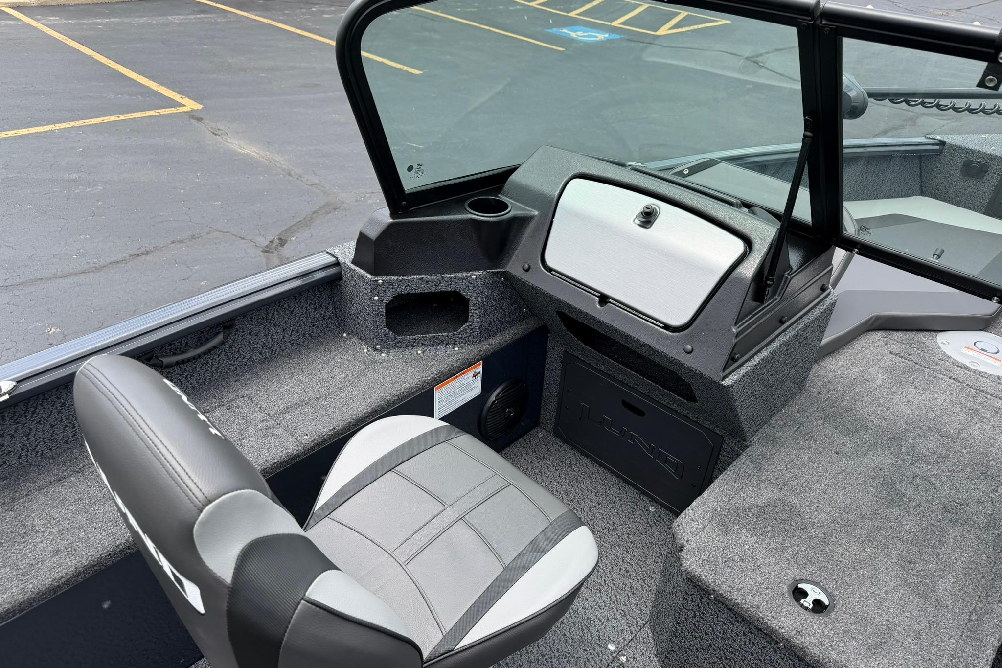 Interior of 2027 Lund 1675 Adventure Sport boat with seating and dashboard view.
