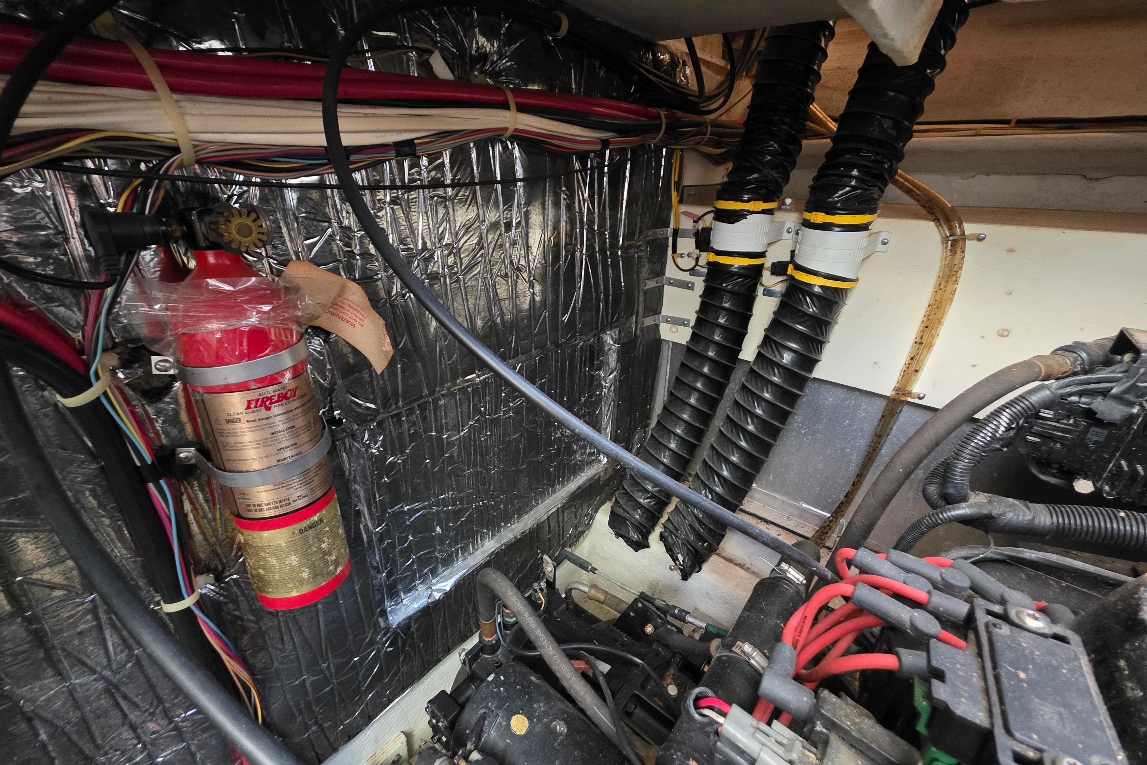 Engine room of 1998 Maxum 3700 SCR with fire extinguisher and wiring.
