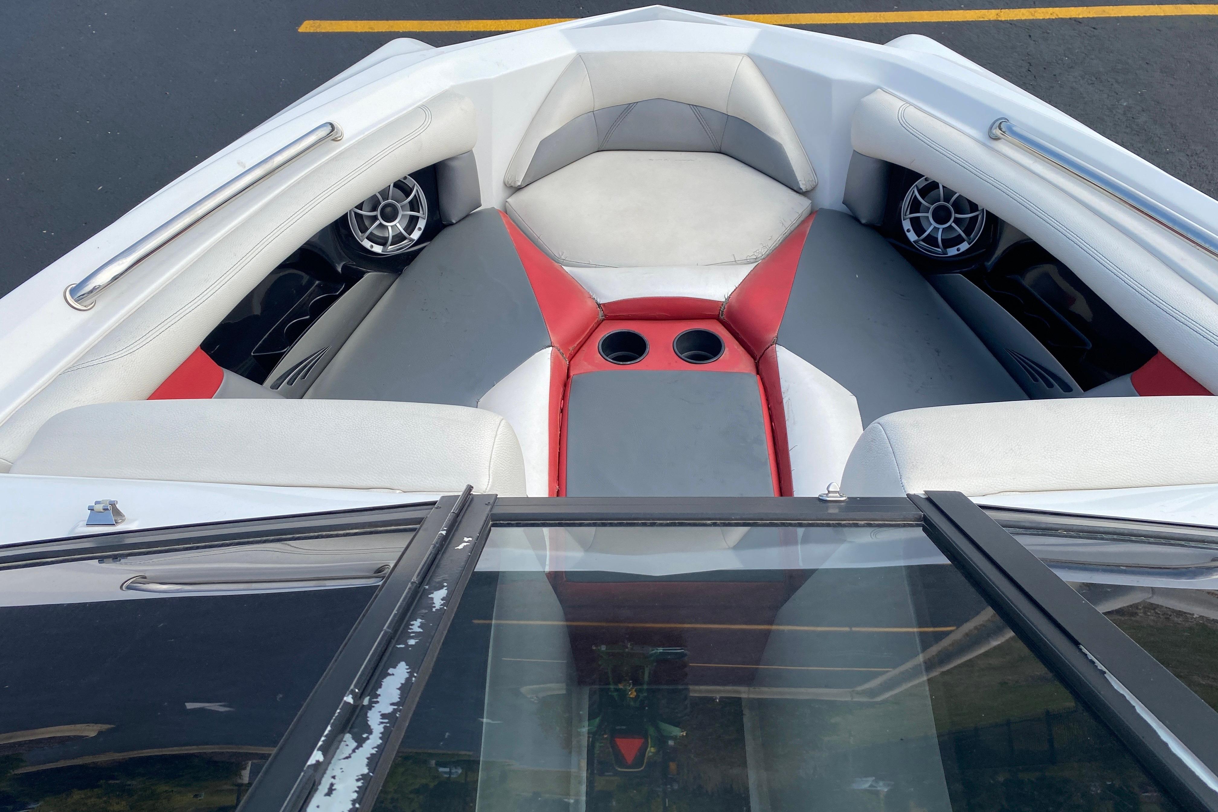 Interior of 2014 Tigé R20 boat with red and gray seating and cup holders.