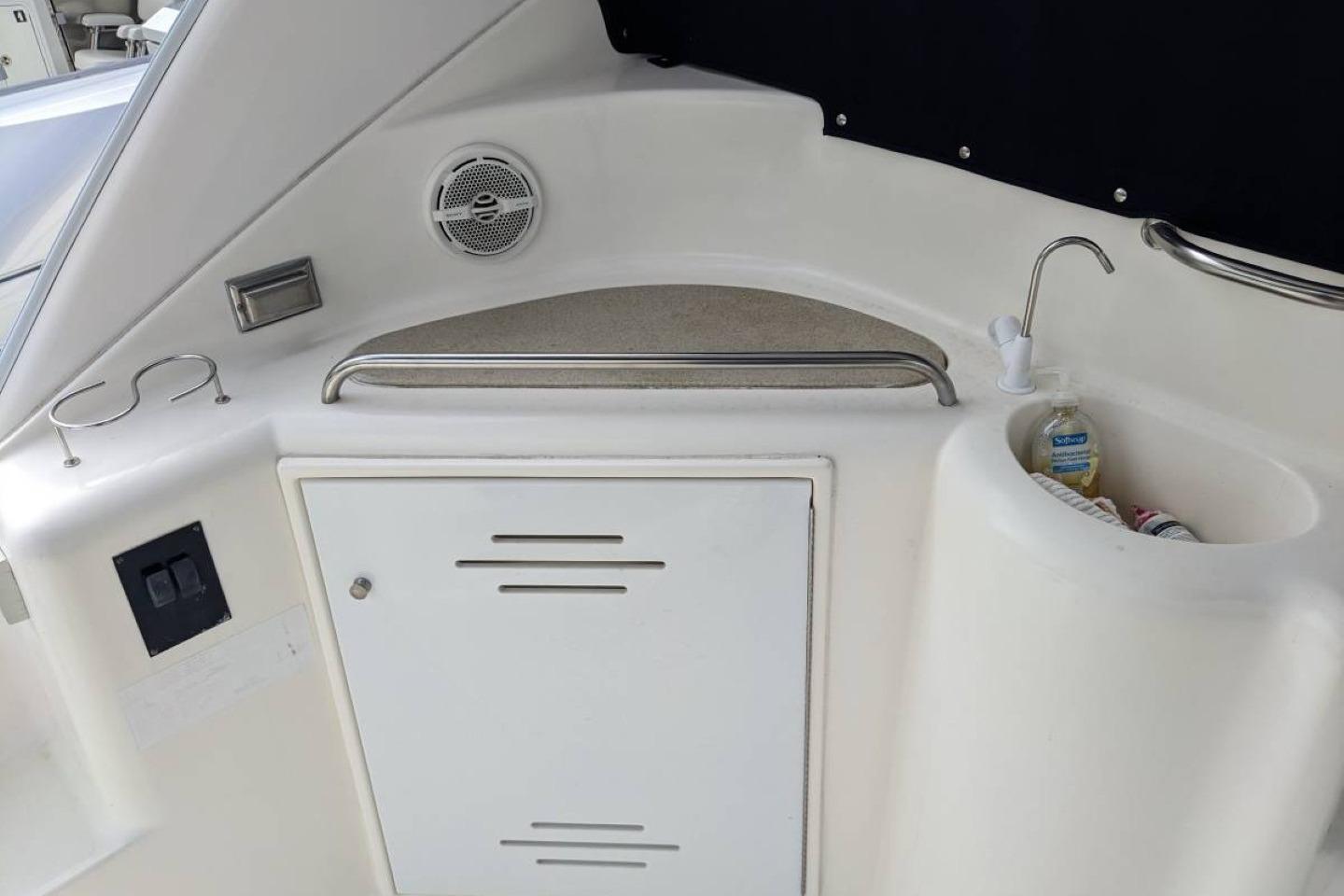 2003 Cruisers 3970 yacht kitchenette with sink, storage, and speaker.