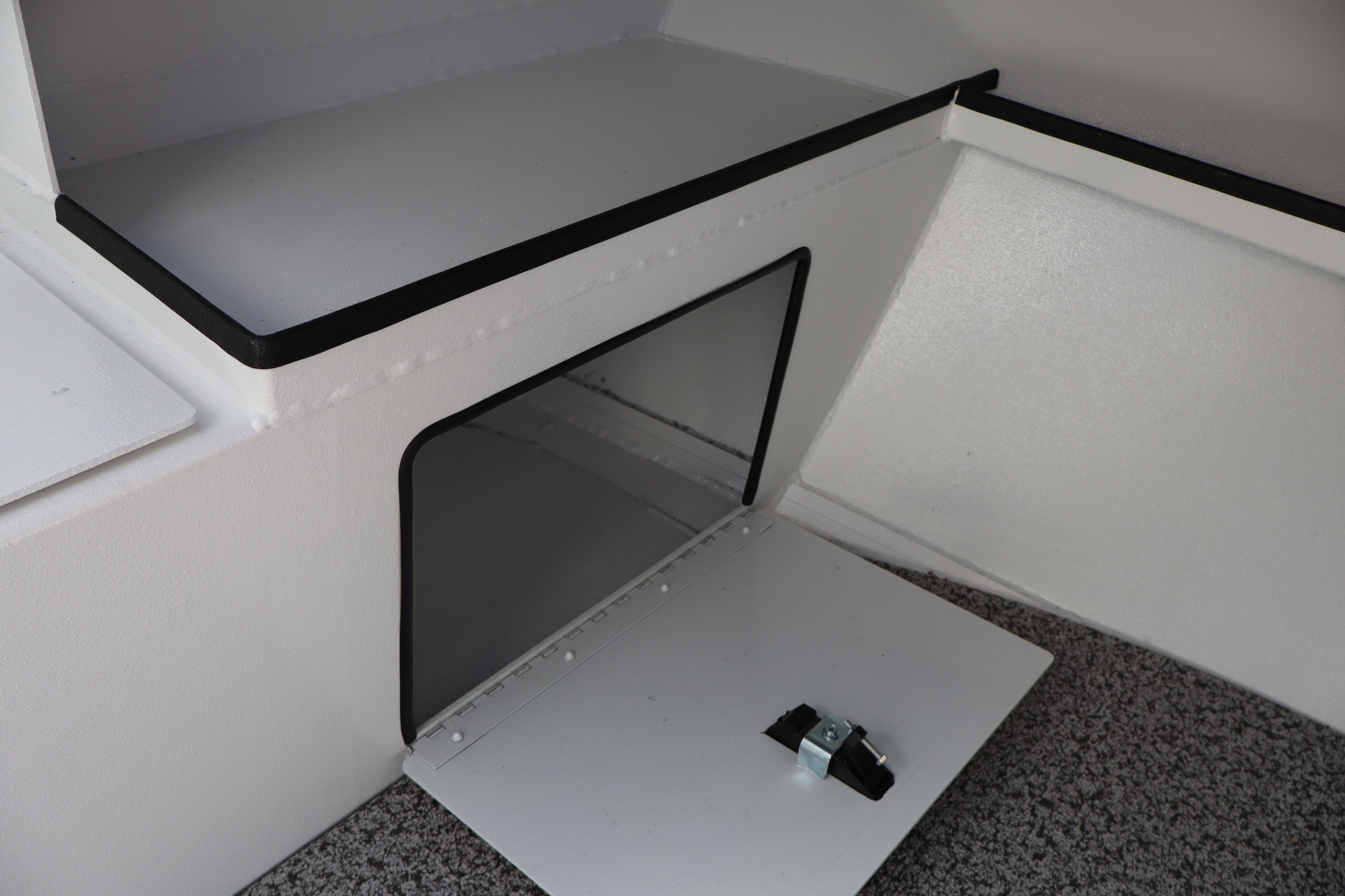 2026 Alumaweld Stryker 202 boat storage compartment with open hatch, showcasing interior space.