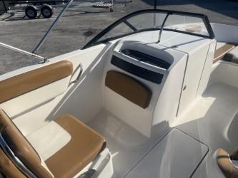 2022 Bayliner VR6 boat interior with tan seating and sleek dashboard design.