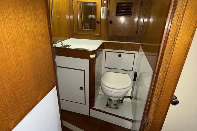 1980 Mao Ta Skye 51 yacht bathroom with wooden cabinetry and compact design.