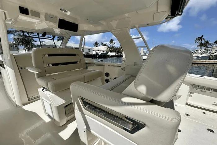 2019 Boston Whaler 350 Realm interior with luxurious seating and marina view.