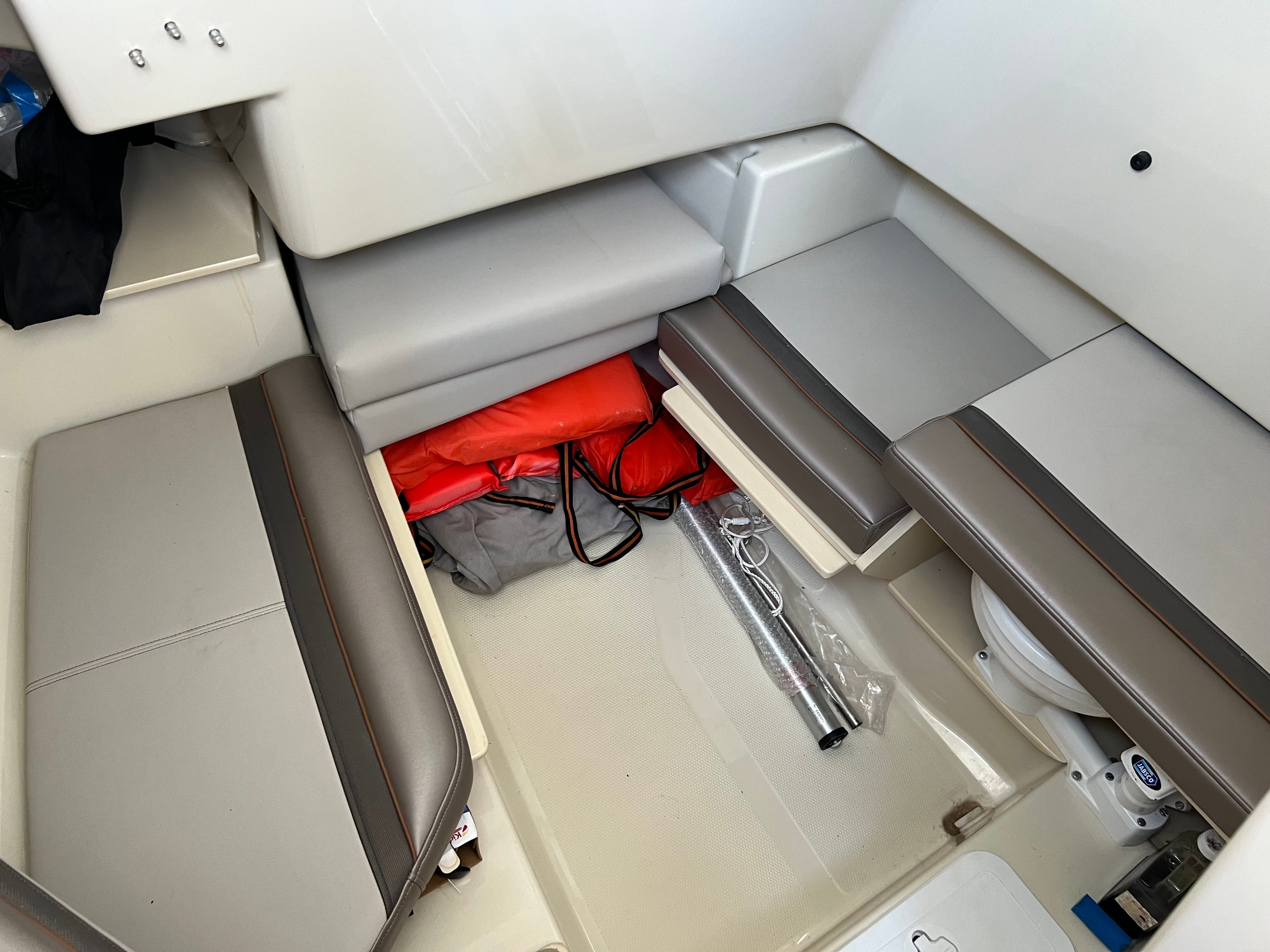 Interior of a Cutwater C-24 CW boat with seating and storage space.
