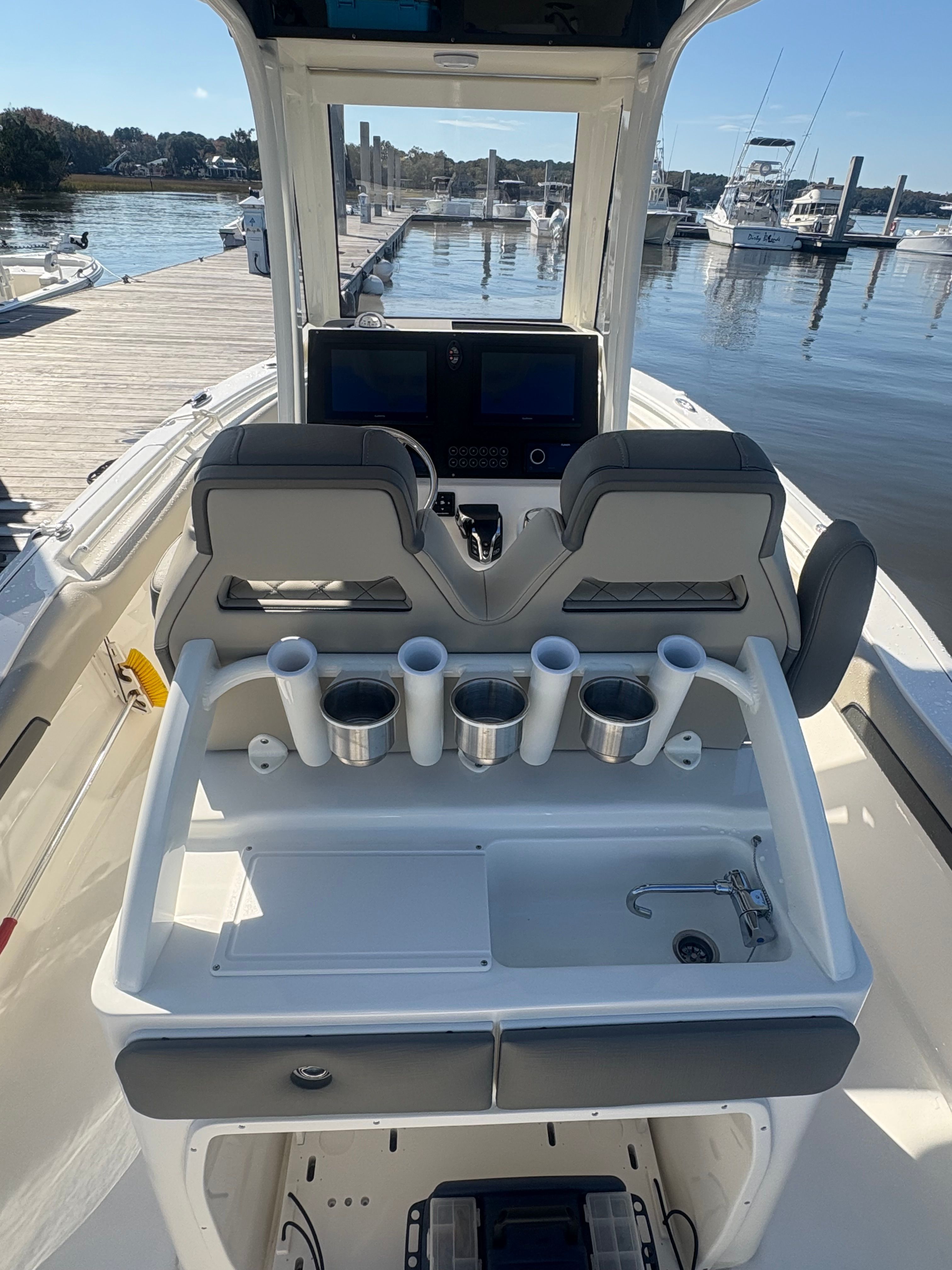 The image shows the cockpit of a 2025 Key West 239 FSR boat docked at a marina.
