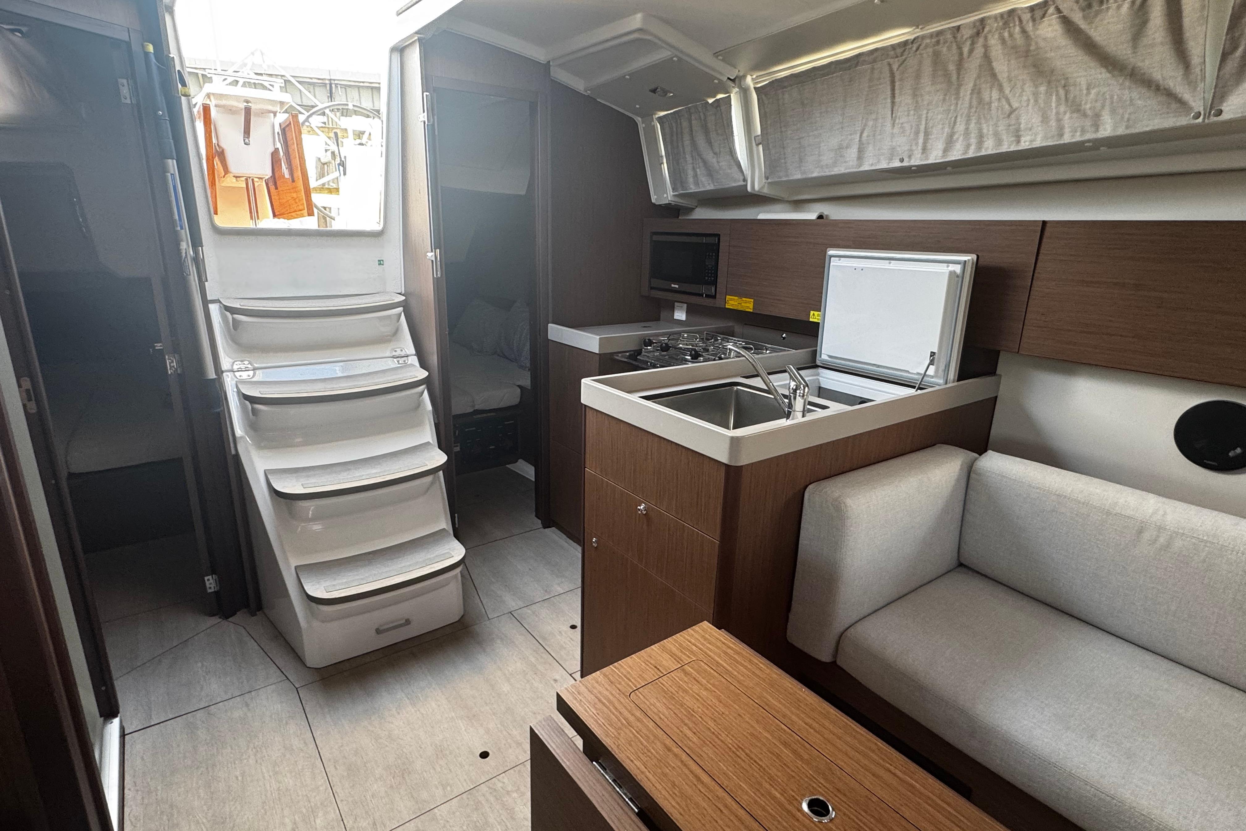 2023 Beneteau Oceanis 38.1 interior with modern kitchen, cozy seating, and elegant design.