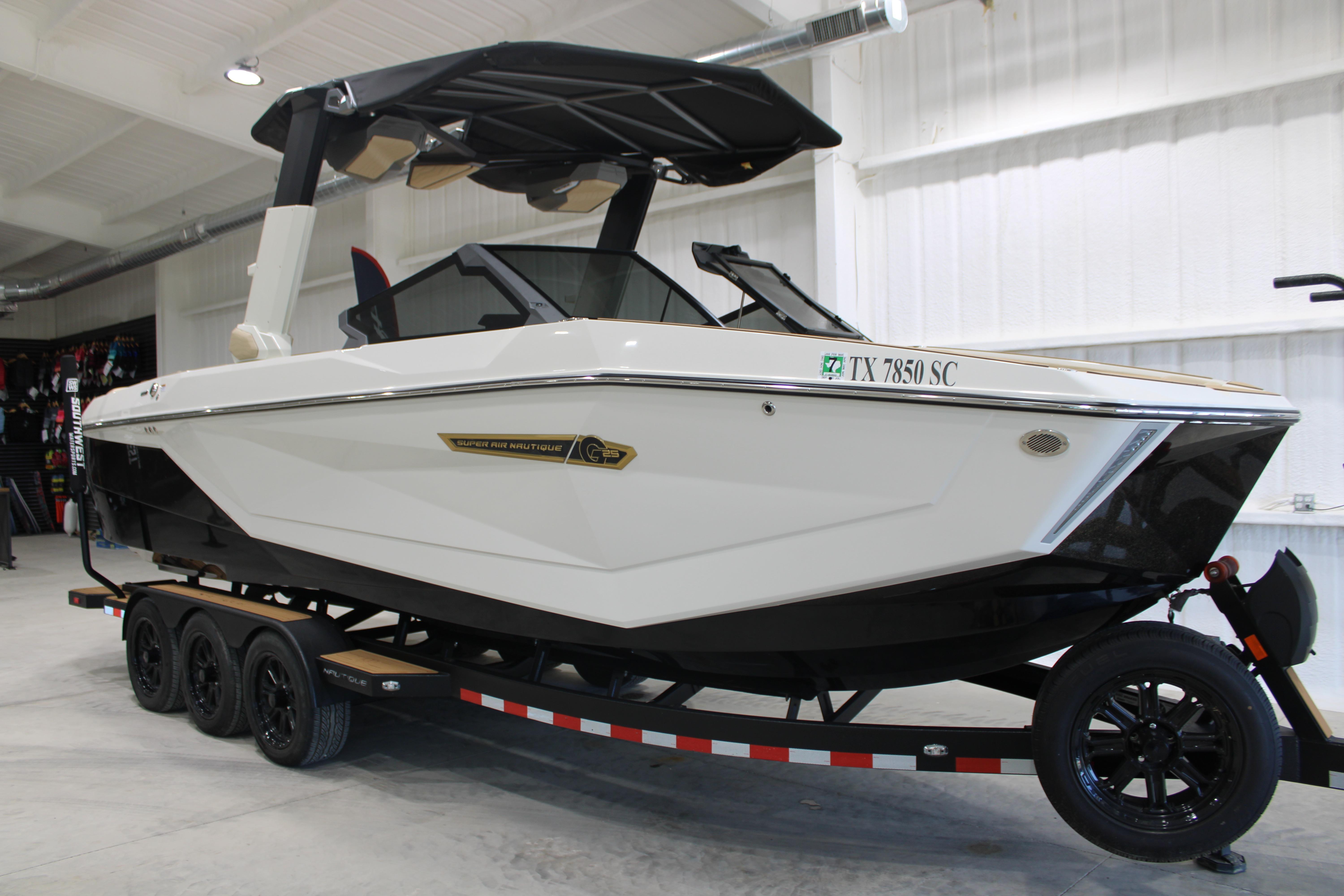 2025 Nautique Super Air Nautique G25 boat on trailer in showroom.