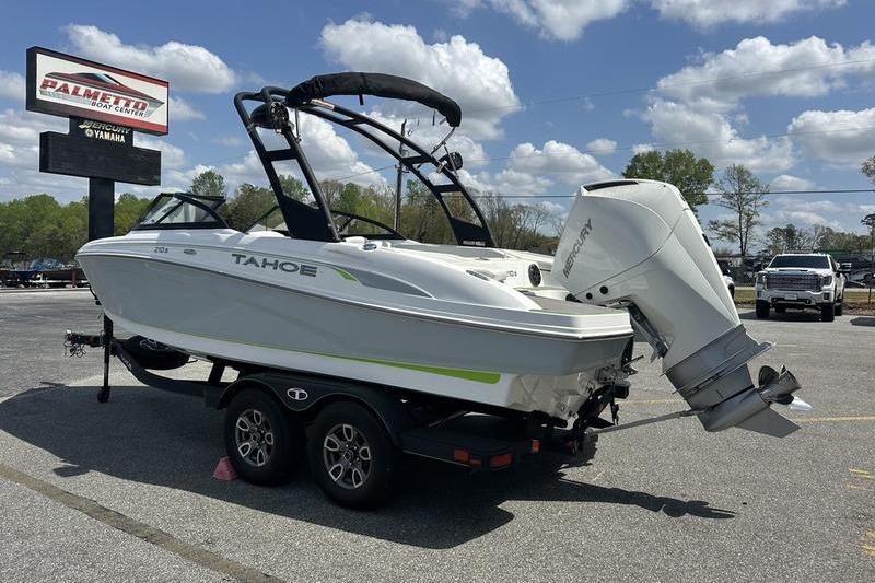 2024 Tahoe 210 S boat on trailer, parked outdoors under a cloudy sky.