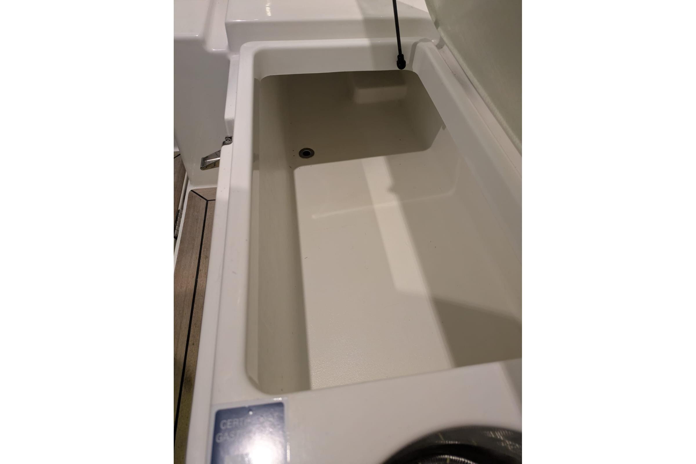 Storage compartment in 2016 Nimbus Boats 305 Coupé, showcasing spacious interior design.