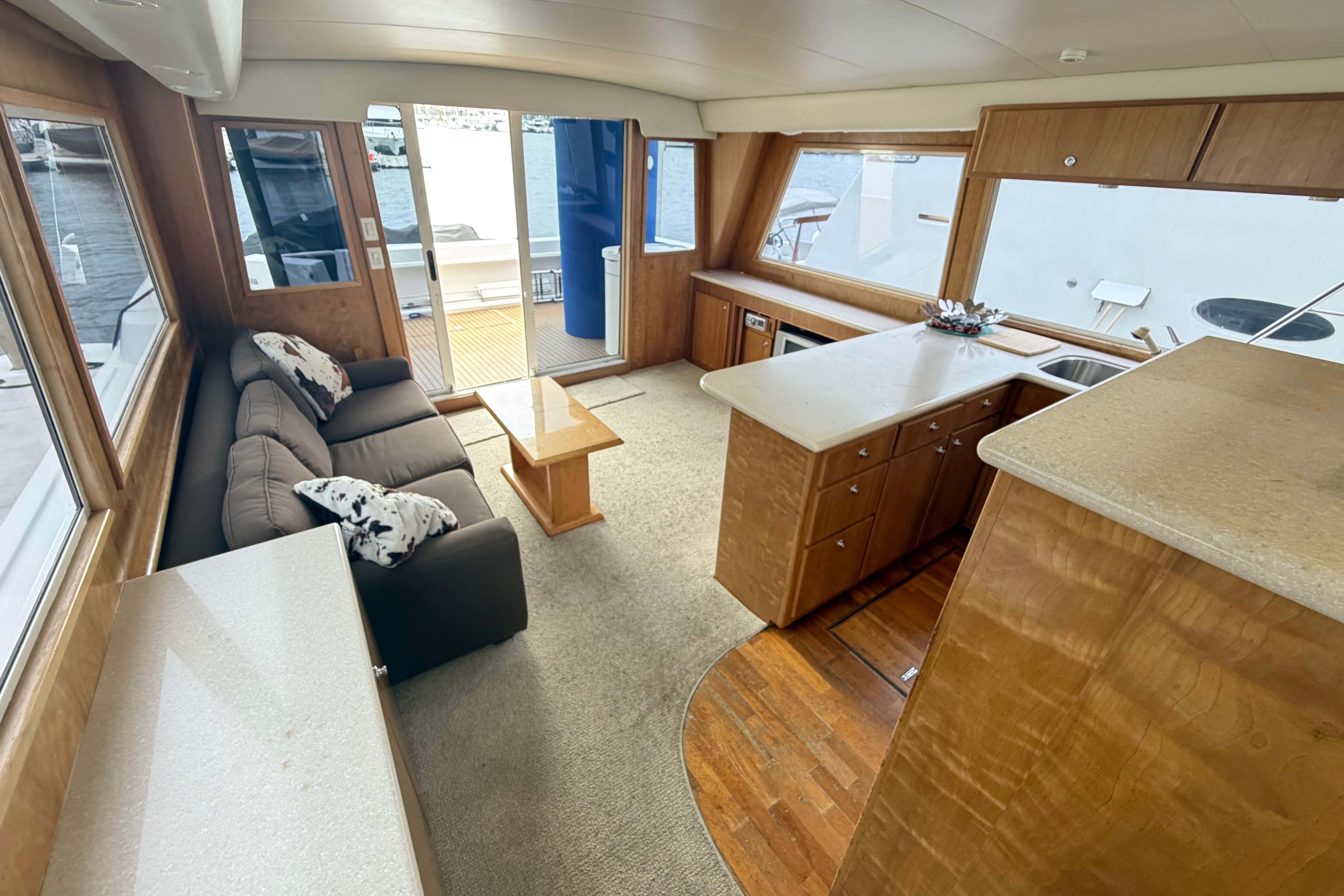 Luxurious 2005 Navigator 53 PILOT HOUSE interior with spacious seating and modern kitchen area.