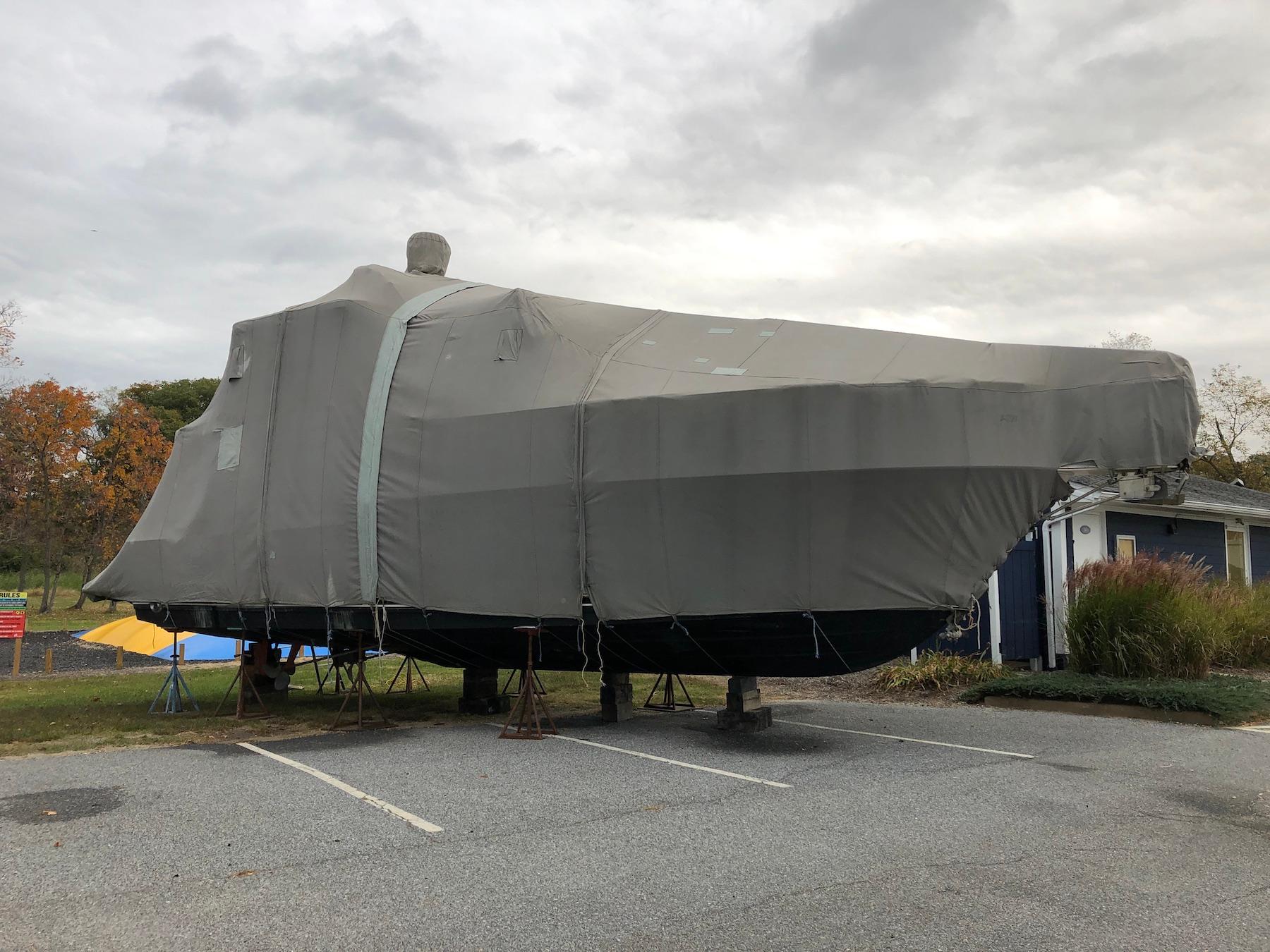 1997 Carver 400 Cockpit Motor Yacht covered and parked outdoors.