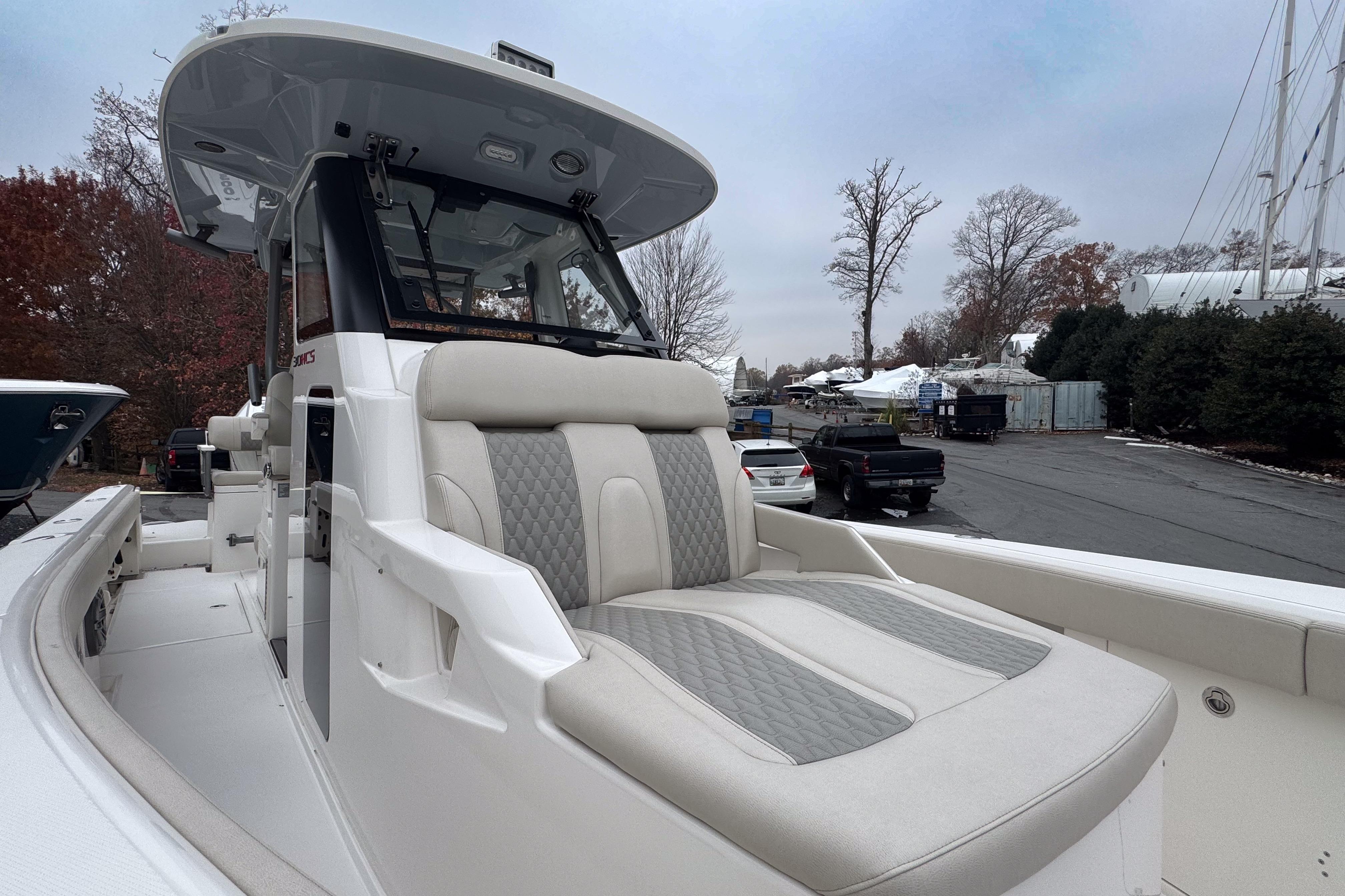 2025 Solace 30 HCS boat with luxurious seating, docked outdoors.