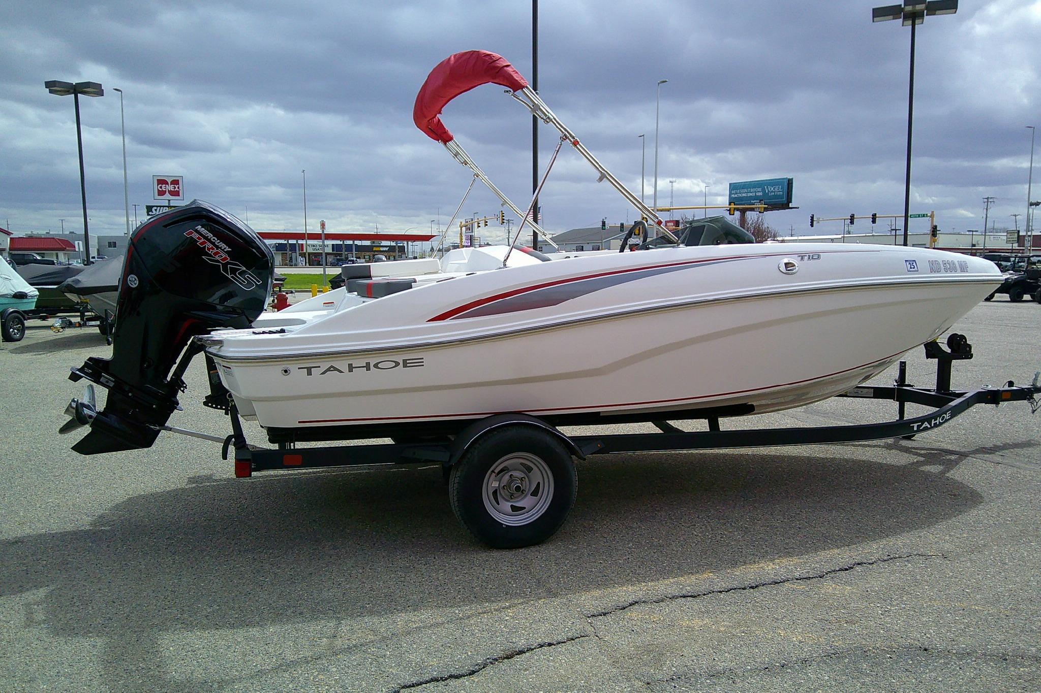 2024 Tahoe T18 boat on trailer in parking lot, overcast sky.