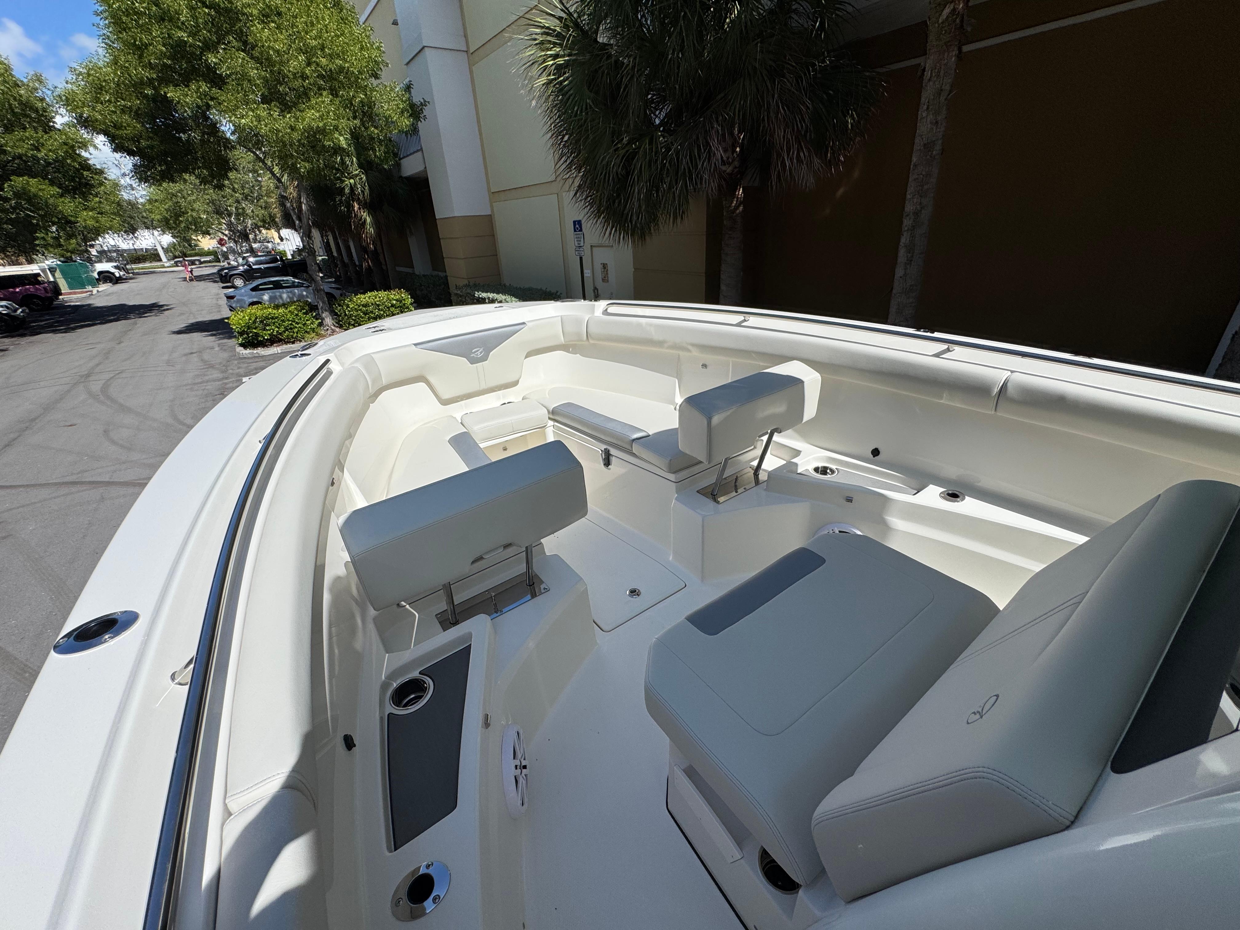 2026 Sailfish 312 CC boat interior with white seating and cup holders.