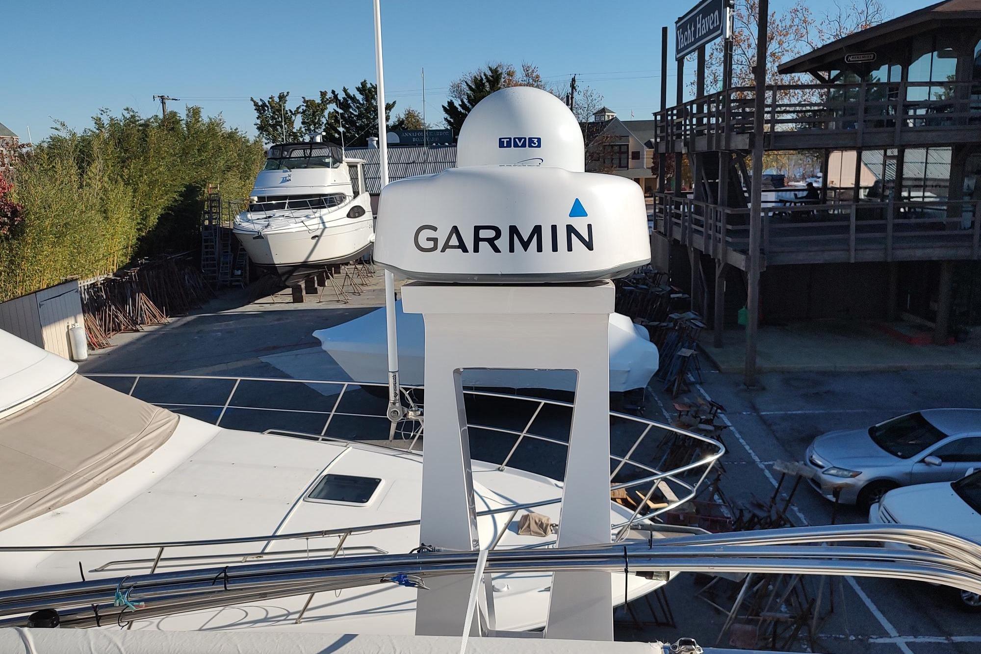 2021 Regal 42 Fly yacht with Garmin radar at a marina.