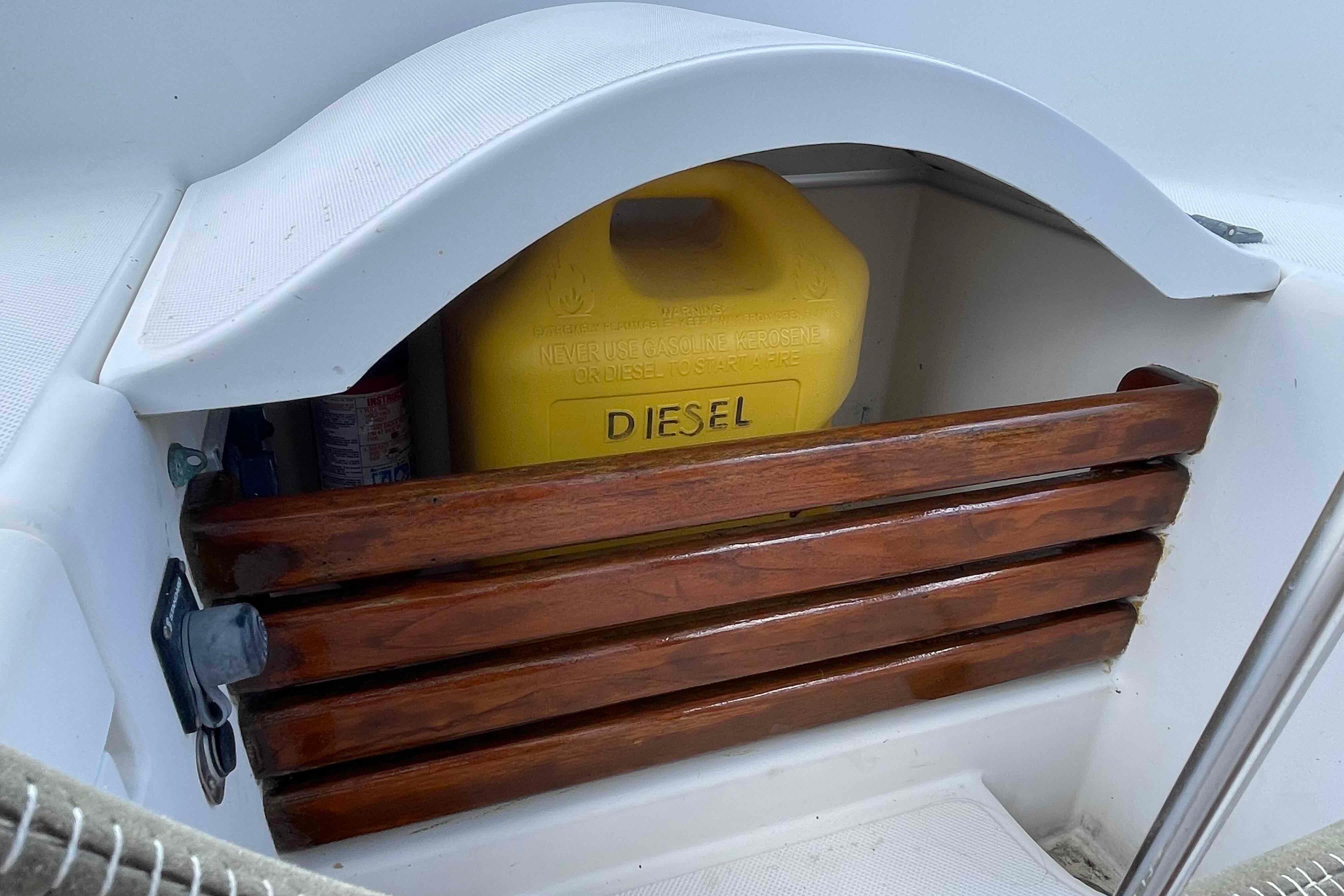 Yellow diesel container on a 1987 Pacific Seacraft 34 sailboat with wooden slats.