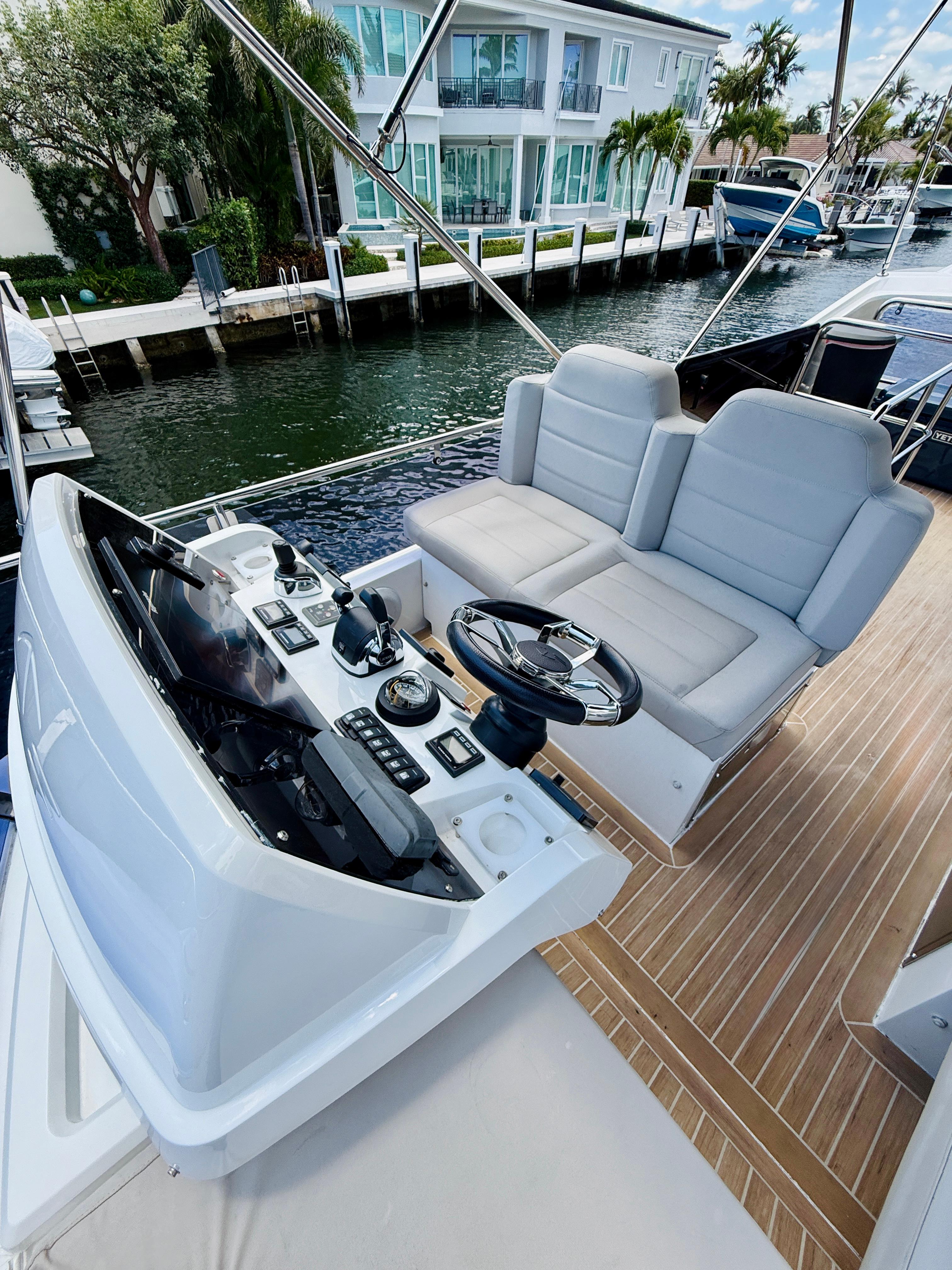 2019 Sealine F430 yacht helm with dual seats and modern controls.
