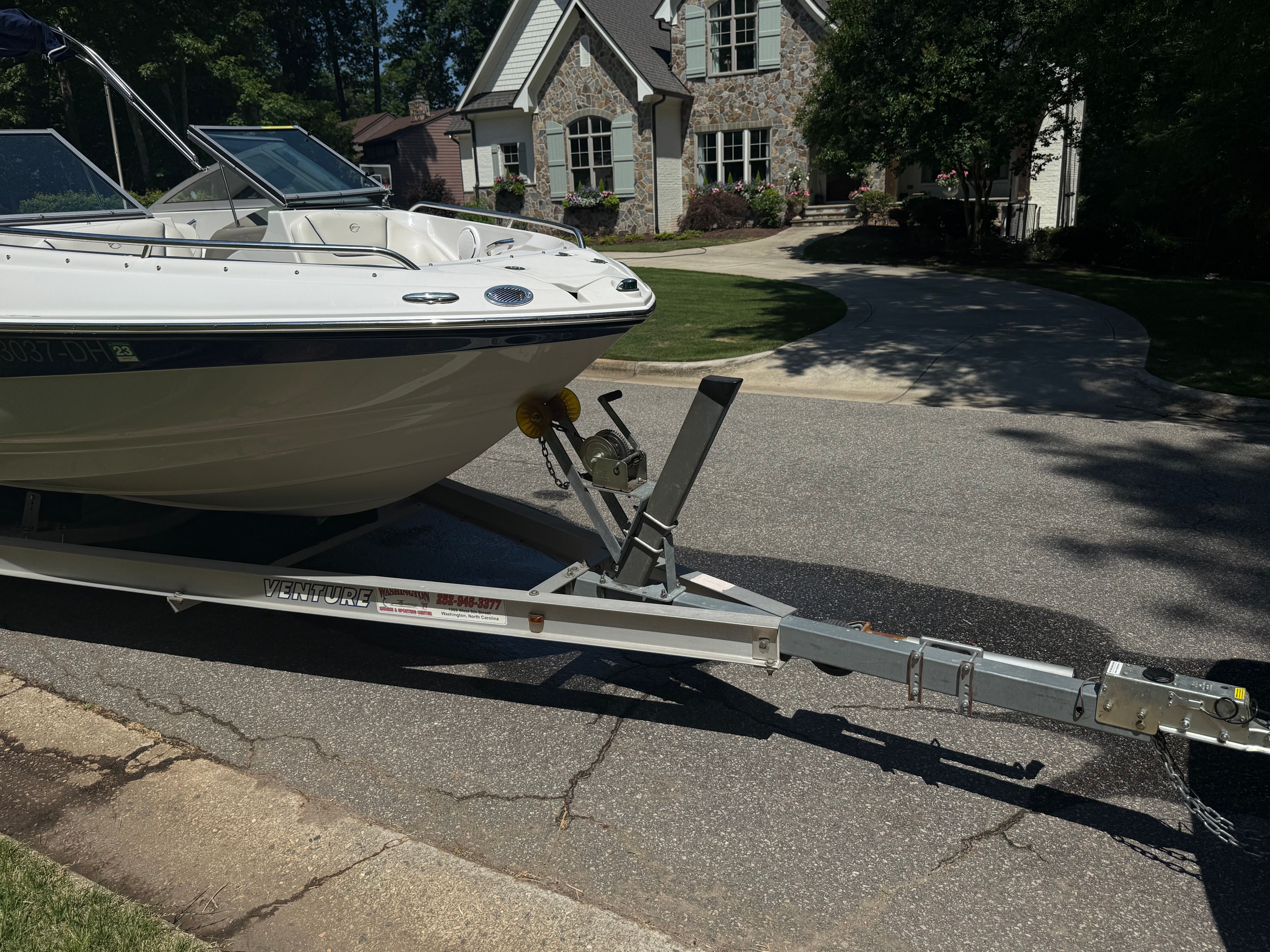 2008 Crownline 210 LX boat on trailer parked in front of house.